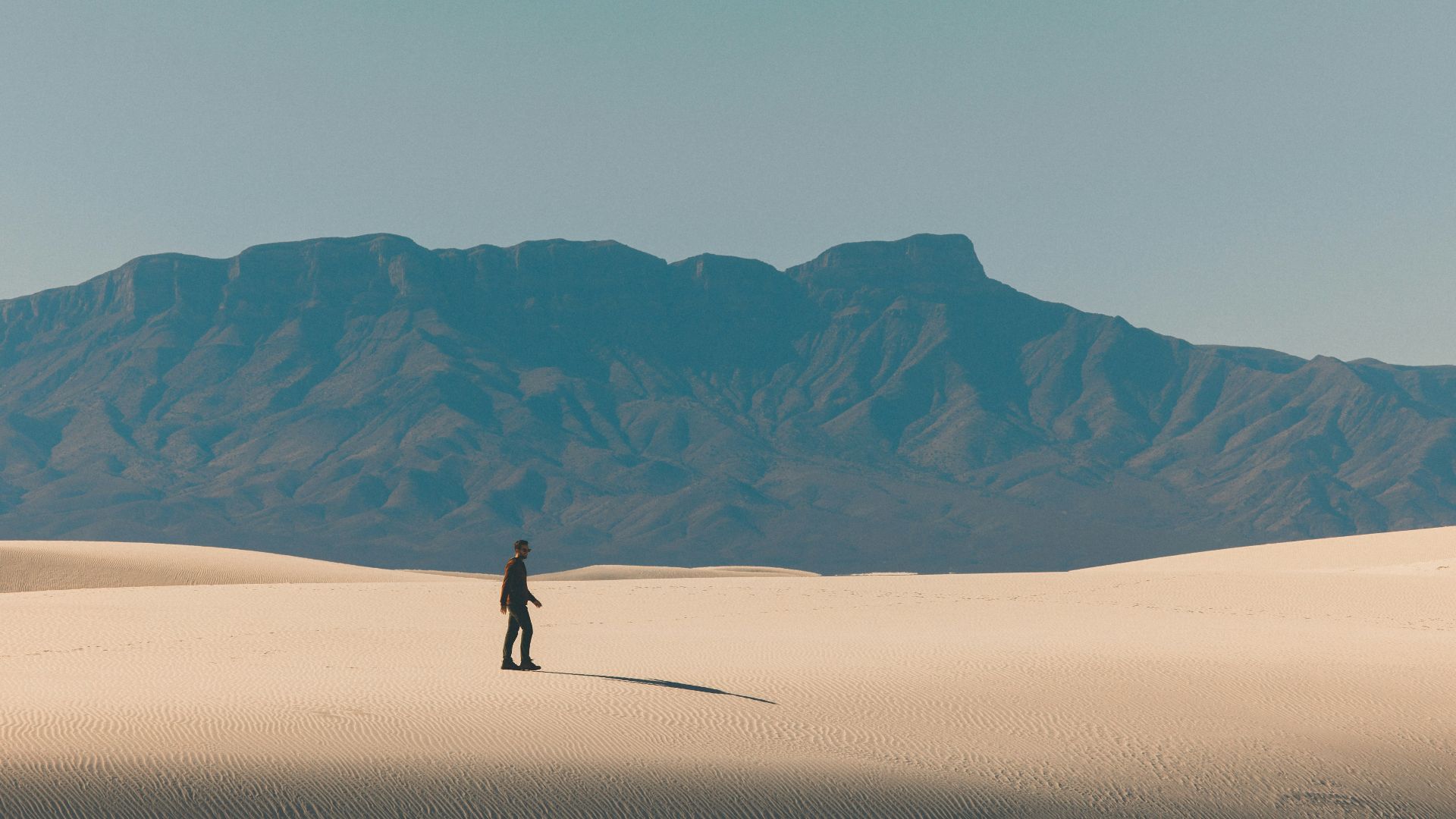 person walking on desert during daytime
