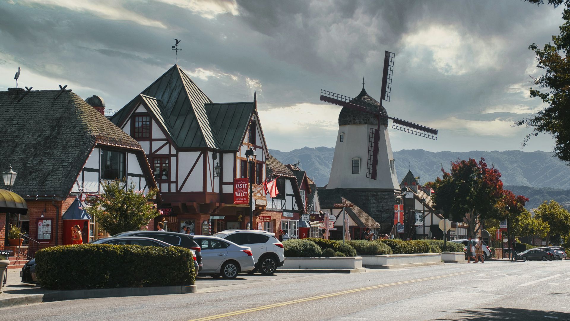 cars parked beside houses during daytime