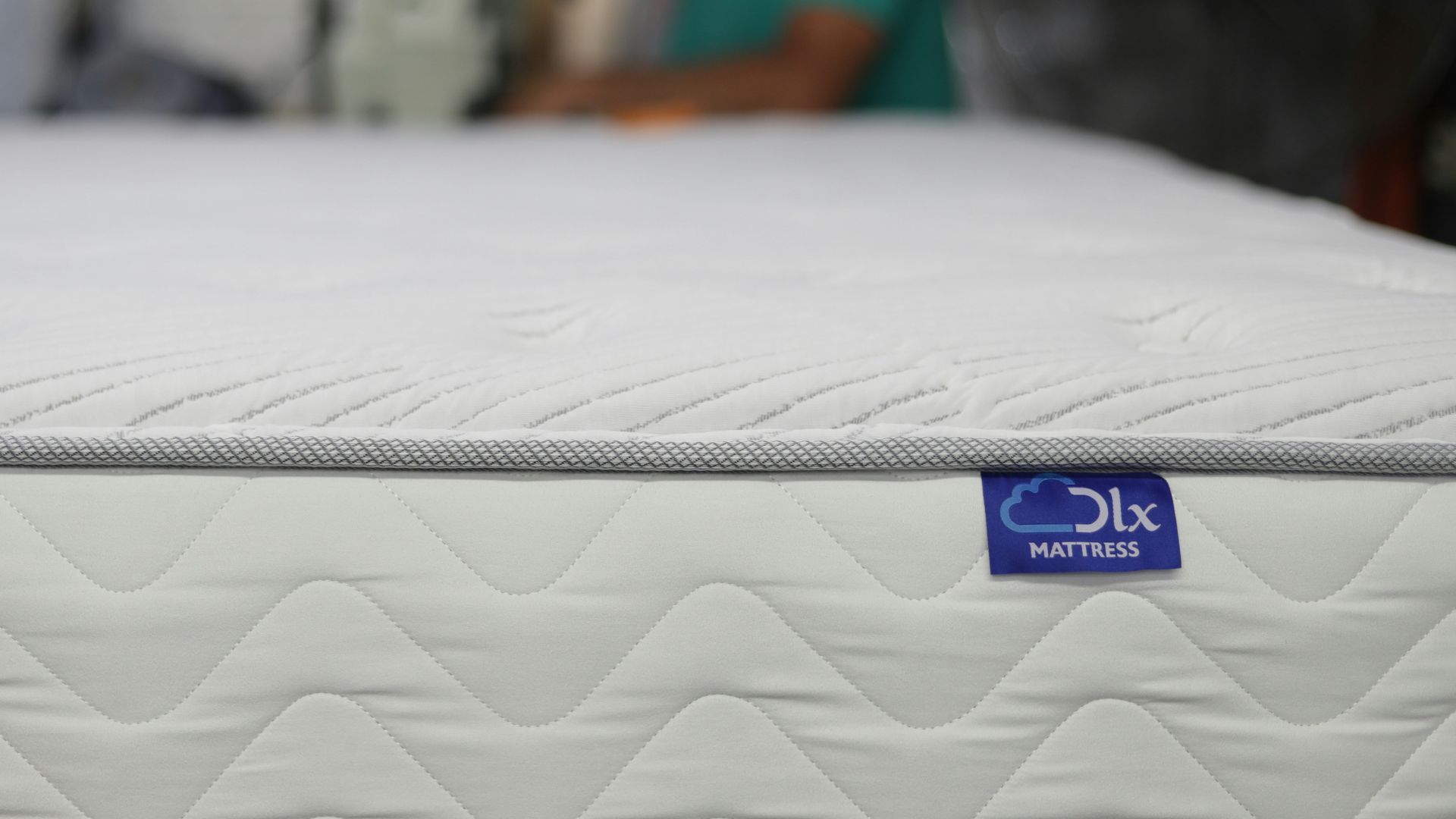 a man is working on a mattress in a warehouse