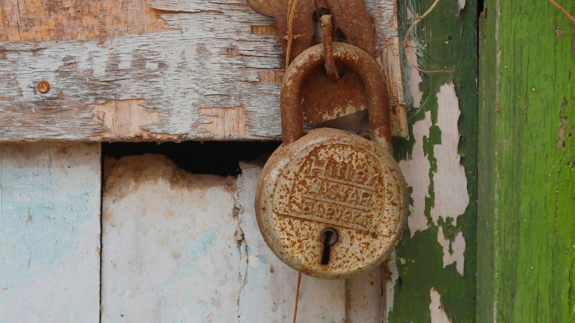 an old door with a rusty lock on it