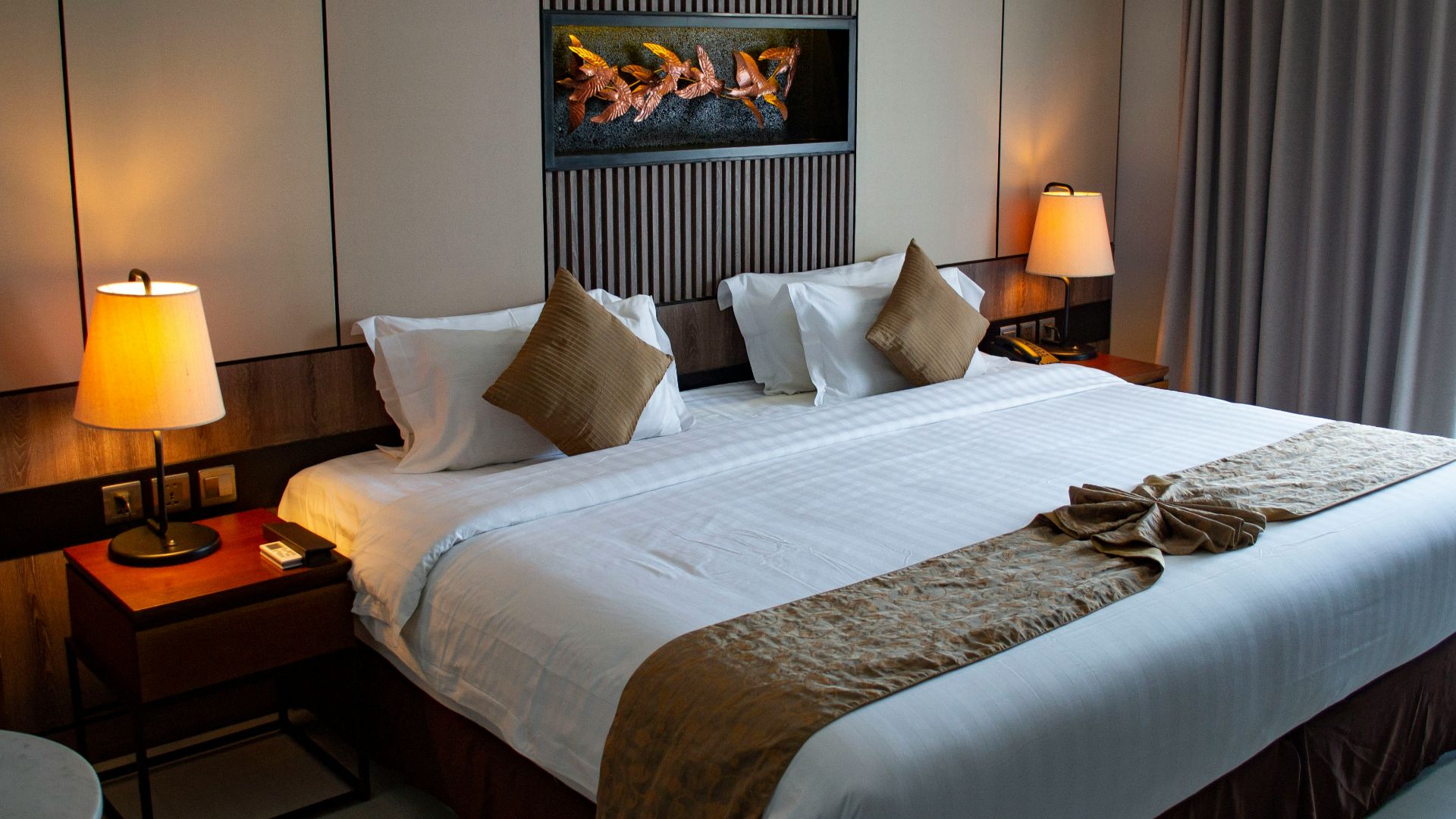 white bed linen with throw pillows