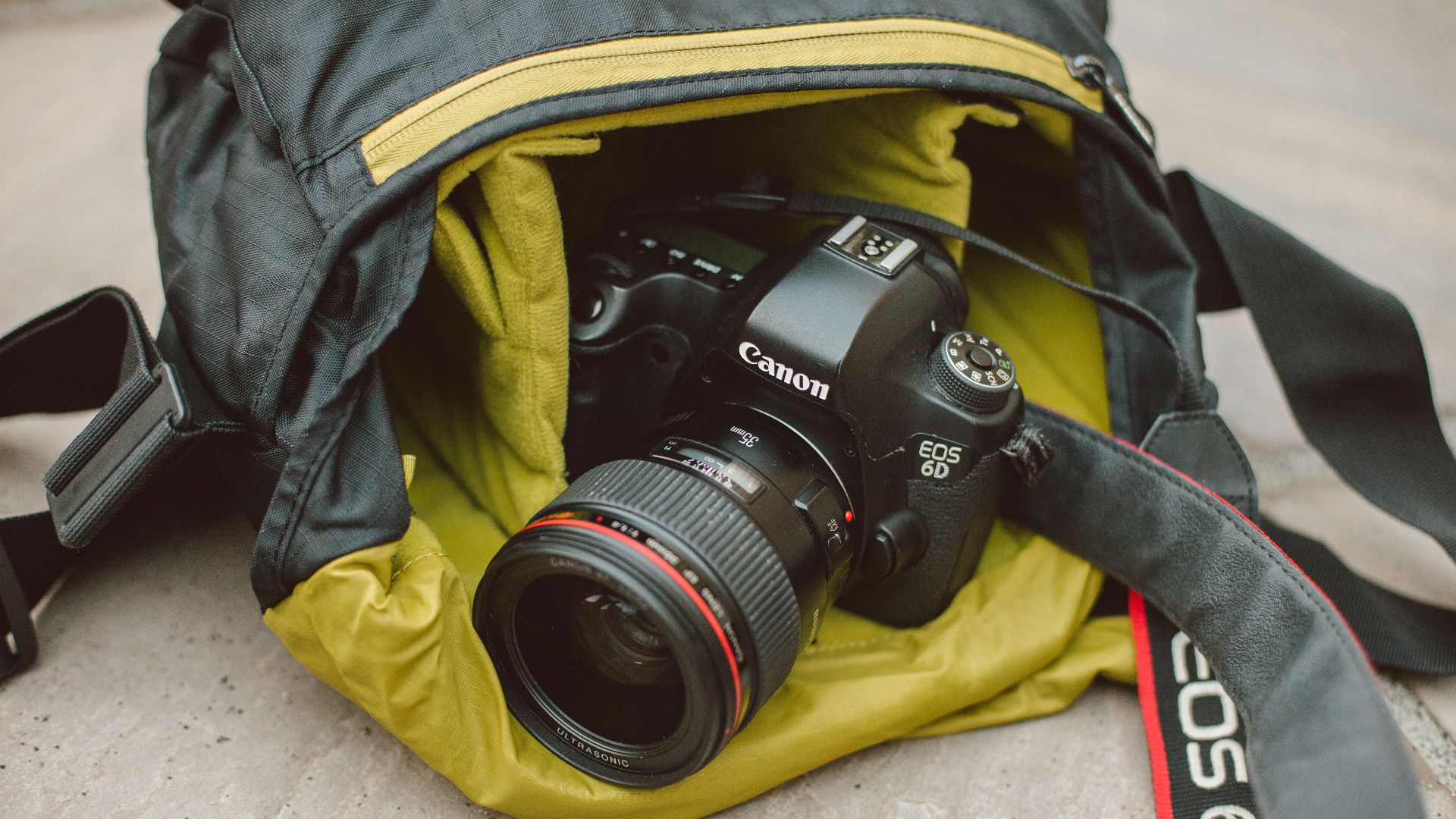 black Canon DSLR camera on bag