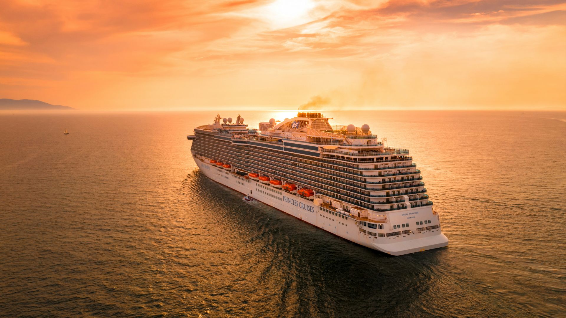 white ship on sea during sunset