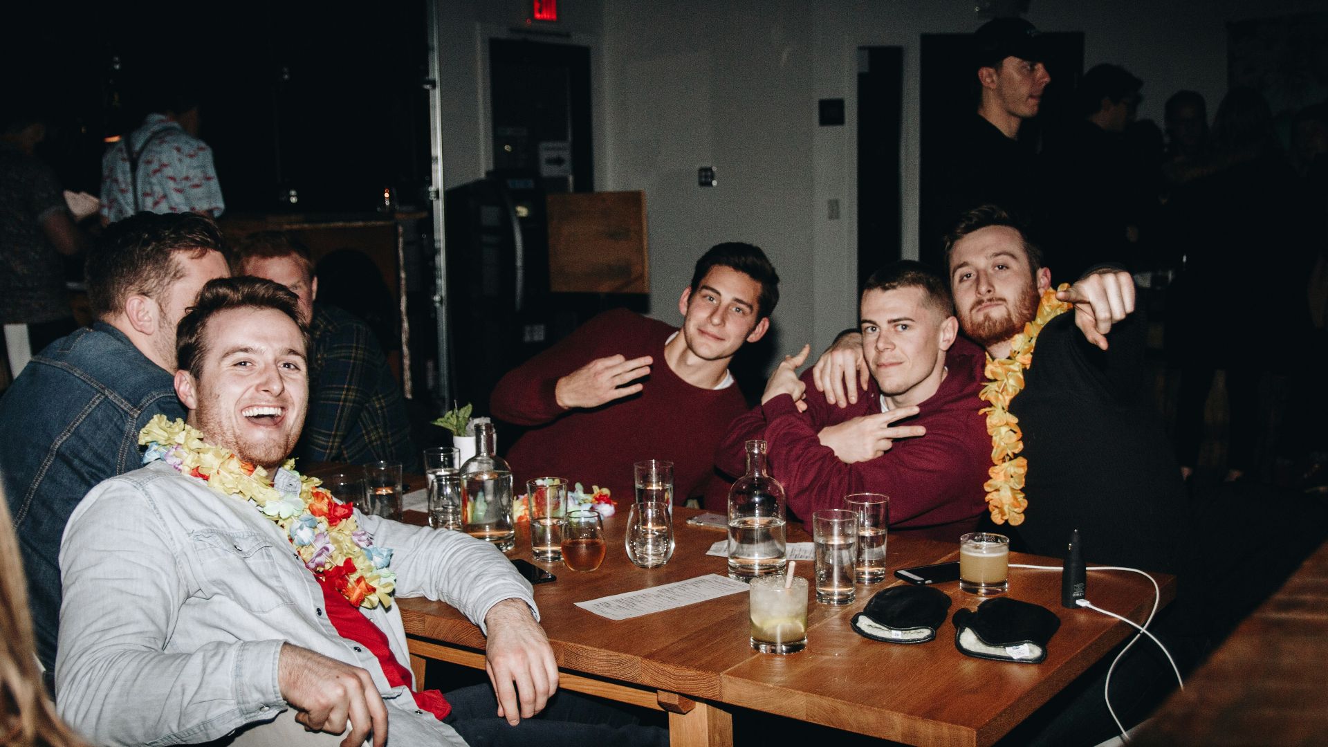 A group of men sitting around a wooden table