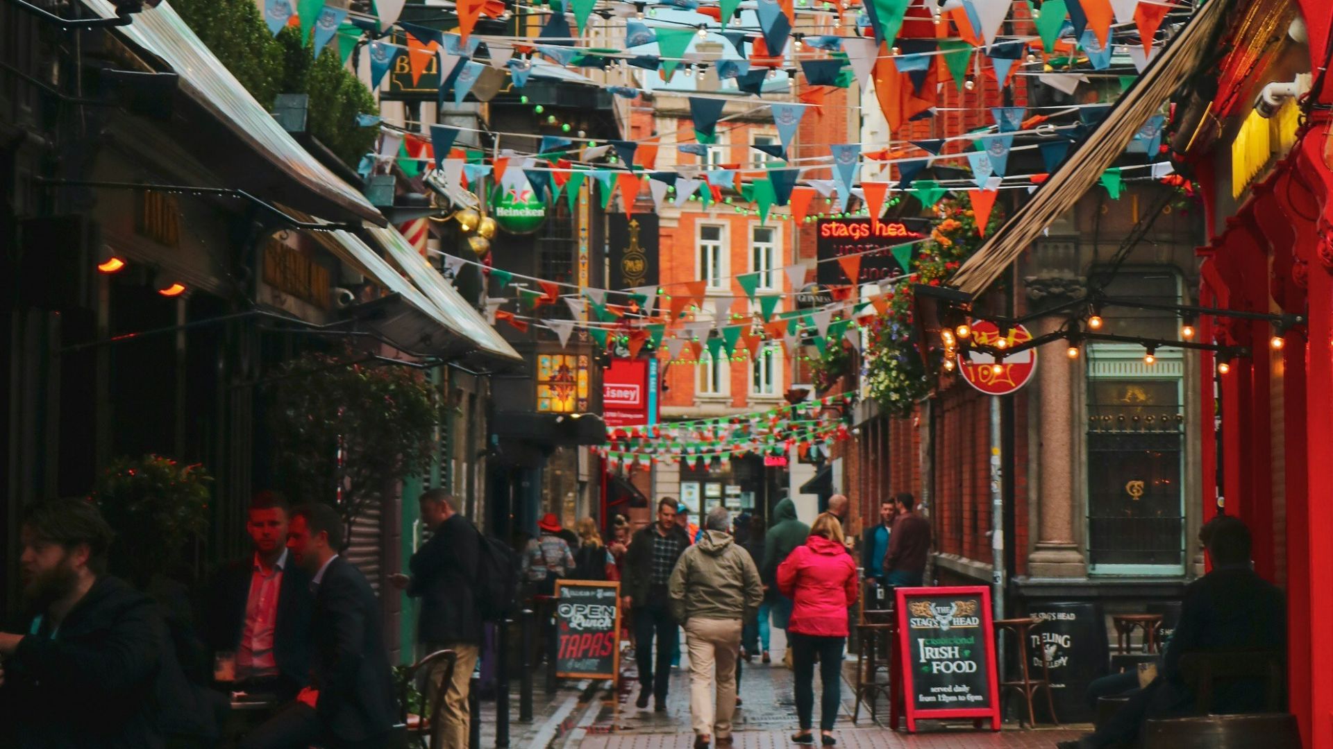 street with multicolored fiesta flags during daytime