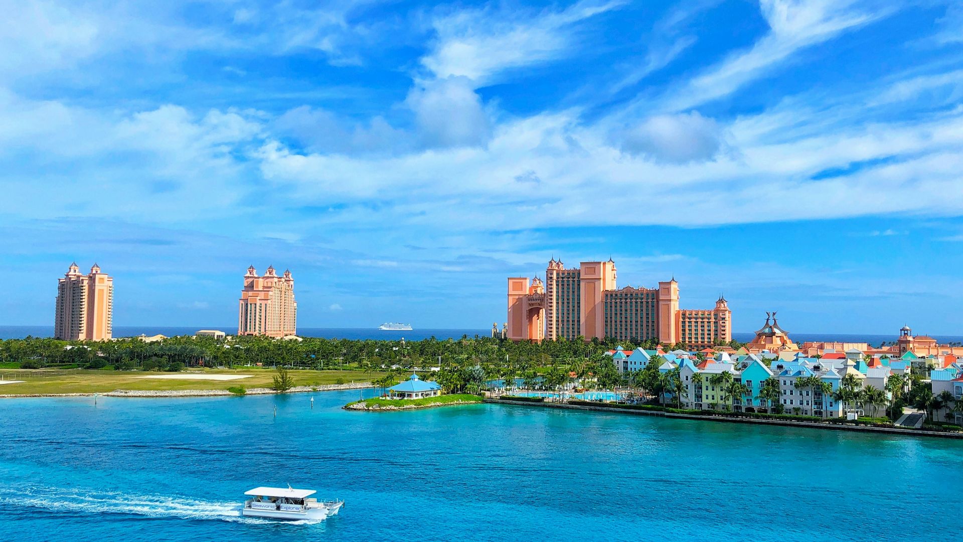 white boat on water near city buildings during daytime