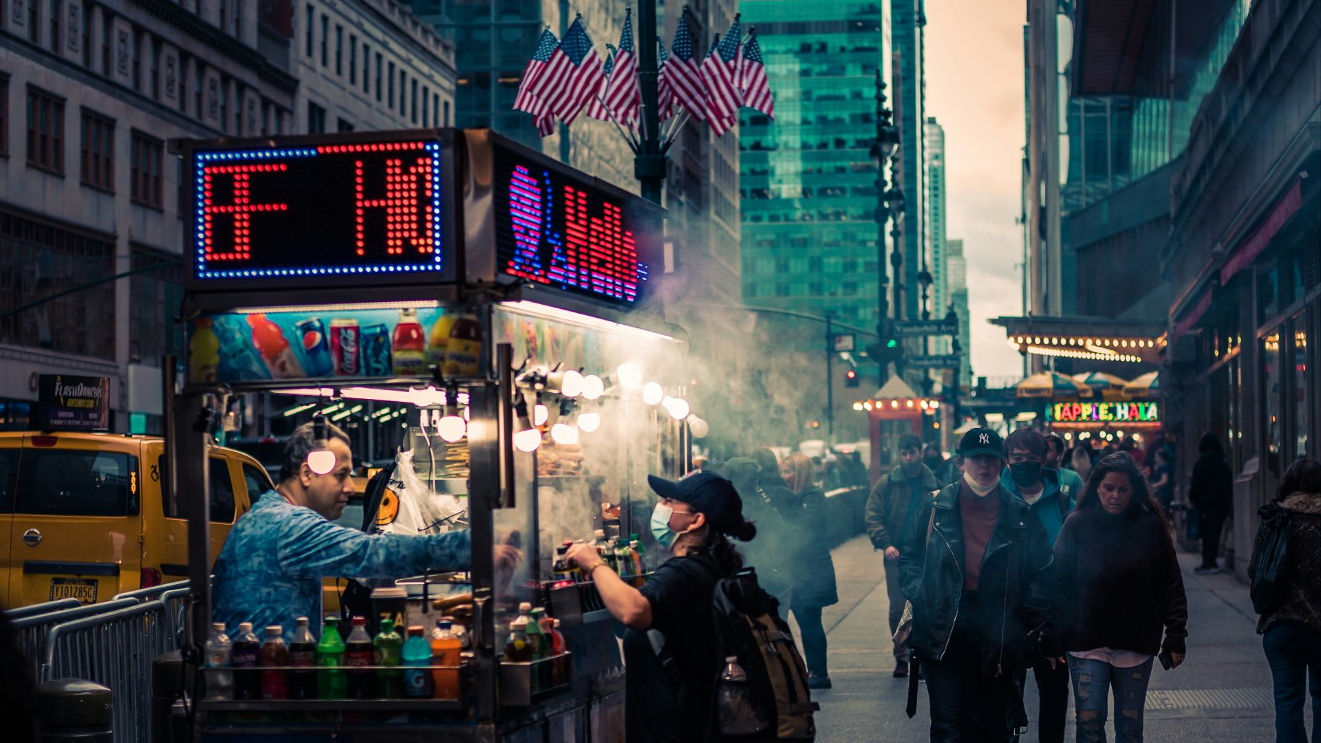 a street with people and food vendors