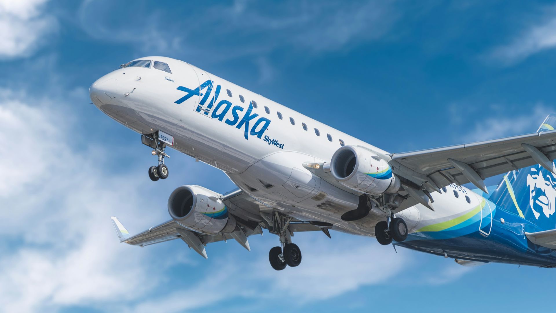 white and blue passenger plane under blue sky during daytime