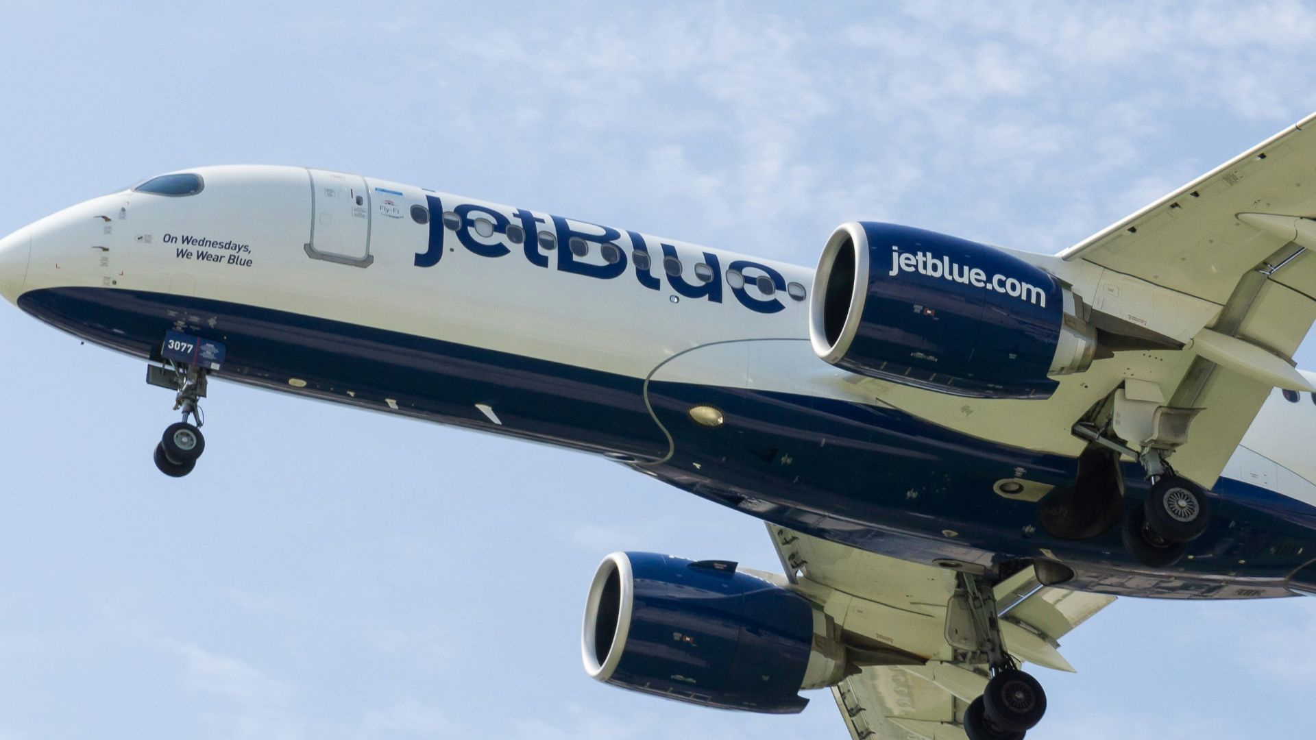 a jetblue airplane is flying in the sky