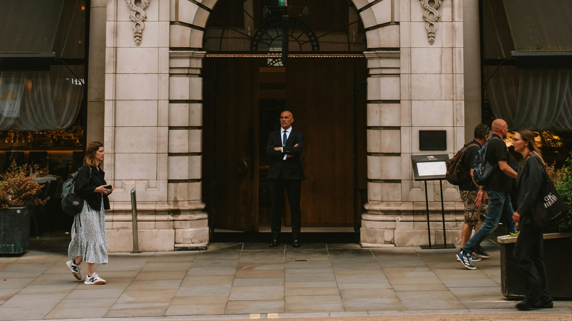 A couple of people that are standing in front of a building
