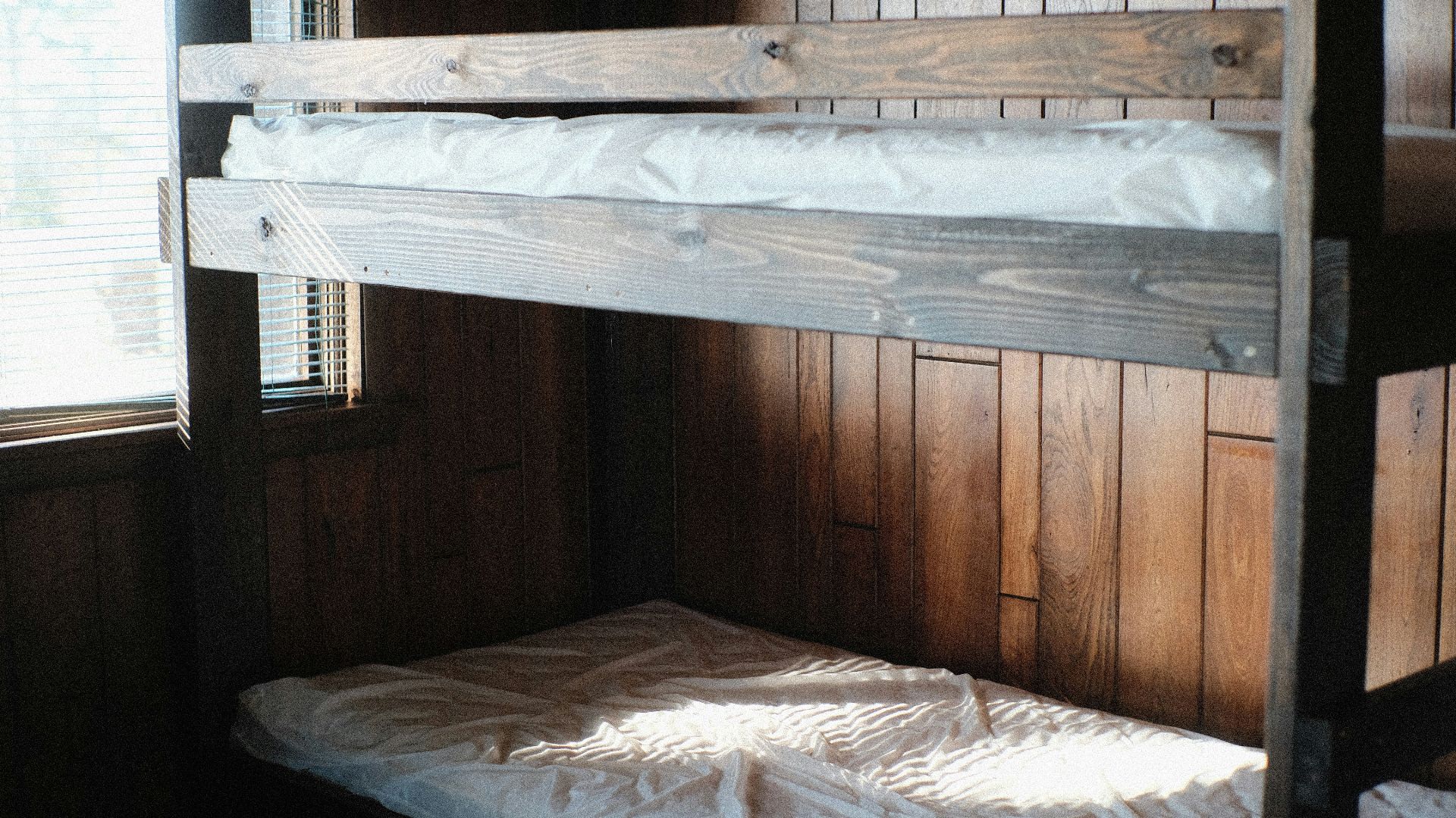 a bunk bed in a room with wooden walls