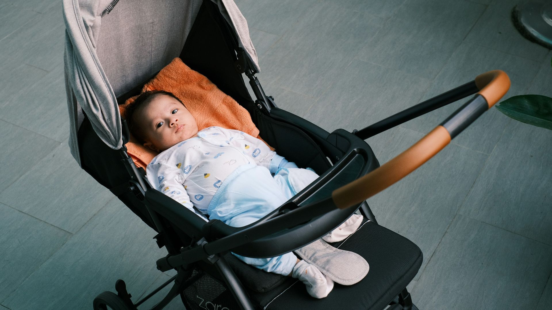 a baby is sleeping in a stroller