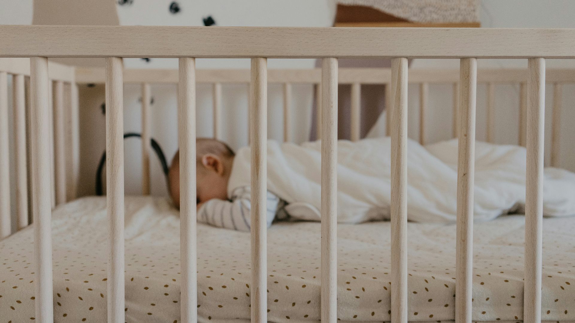 a person sleeping in a crib