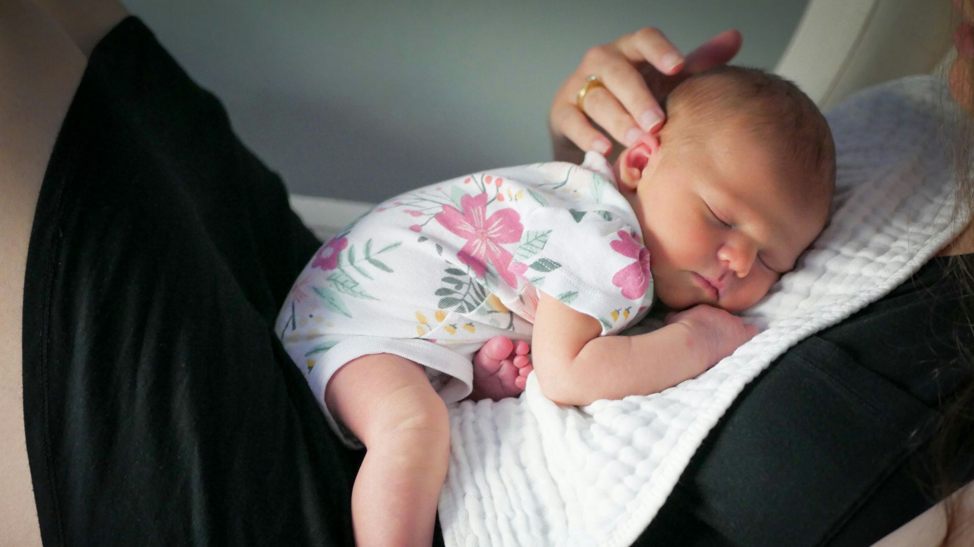 a woman holding a baby in her arms
