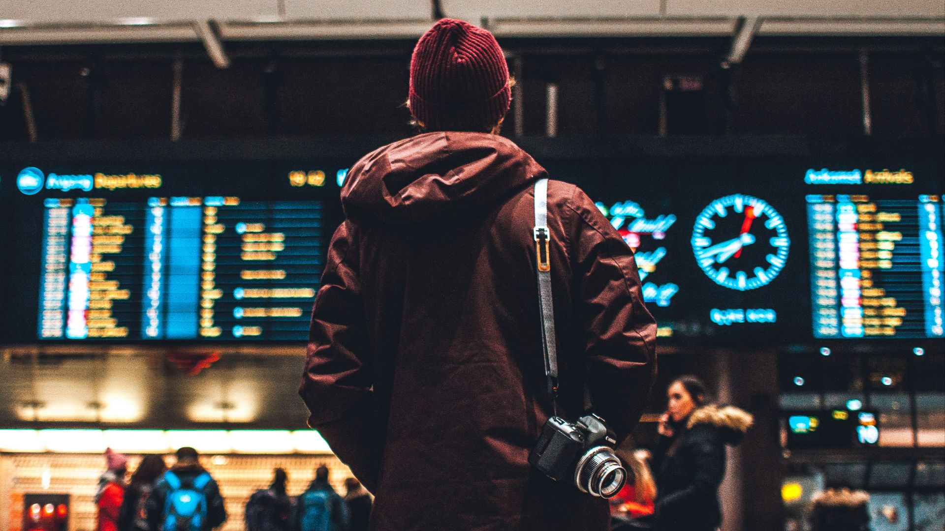 person looking up to the flight schedules