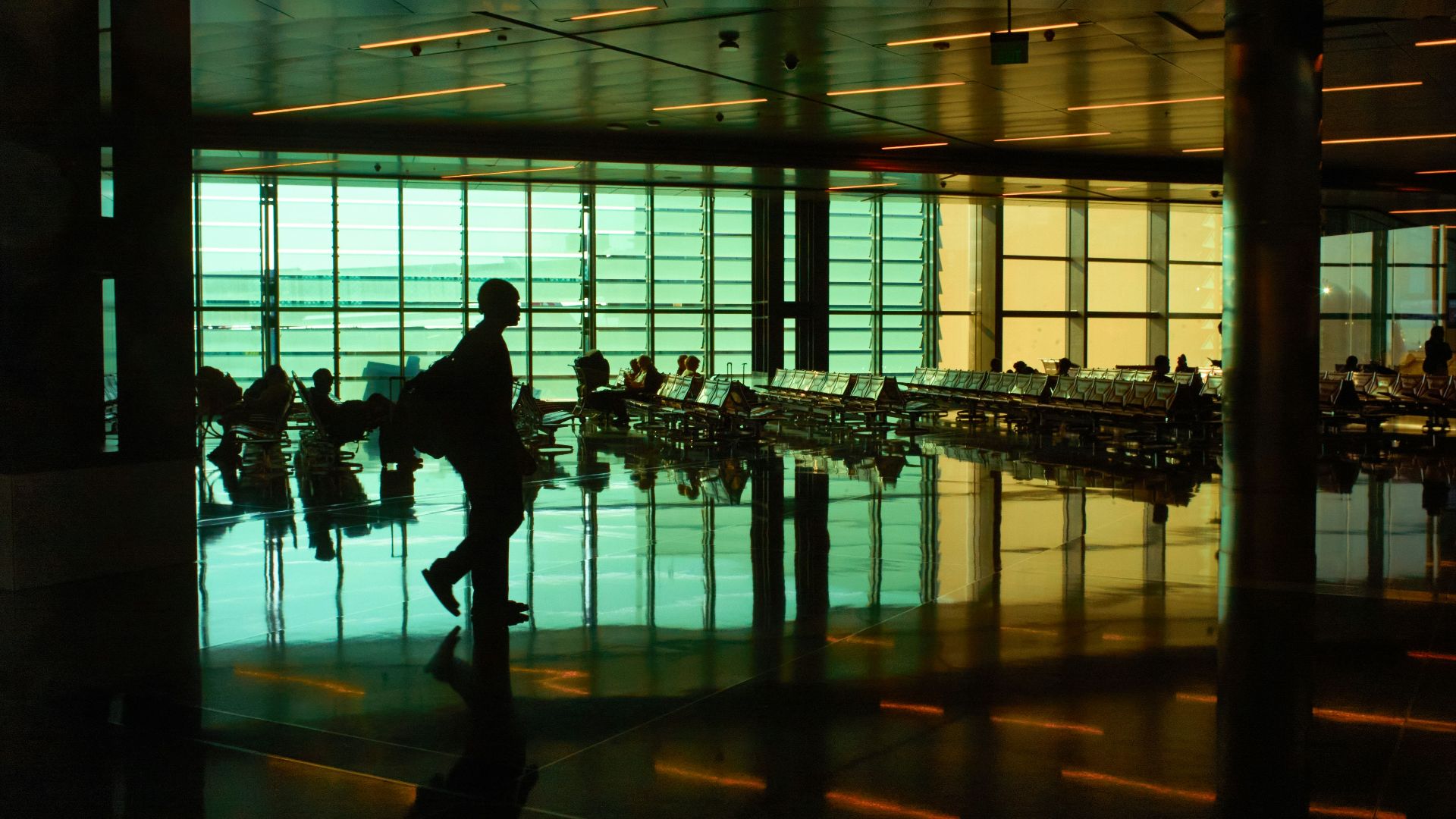 a man is walking through an airport terminal