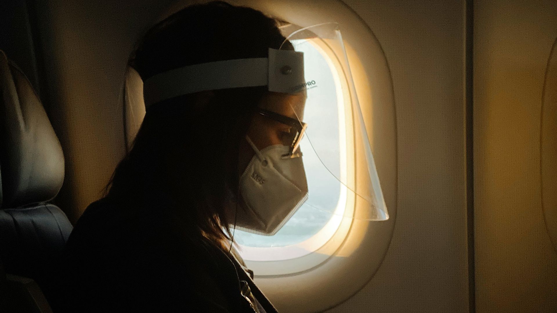 man in black jacket wearing white headphones