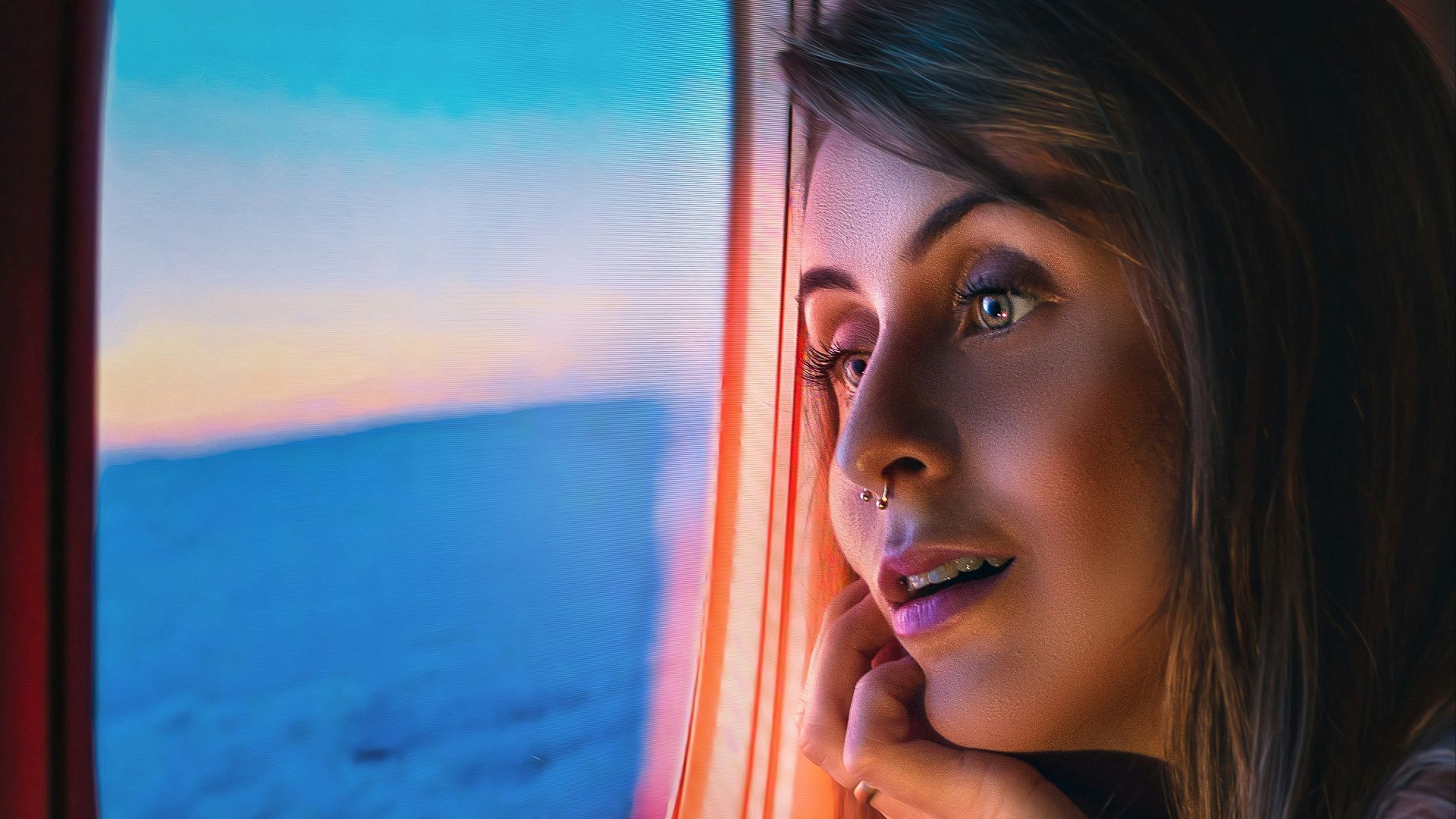 a woman looking out of an airplane window