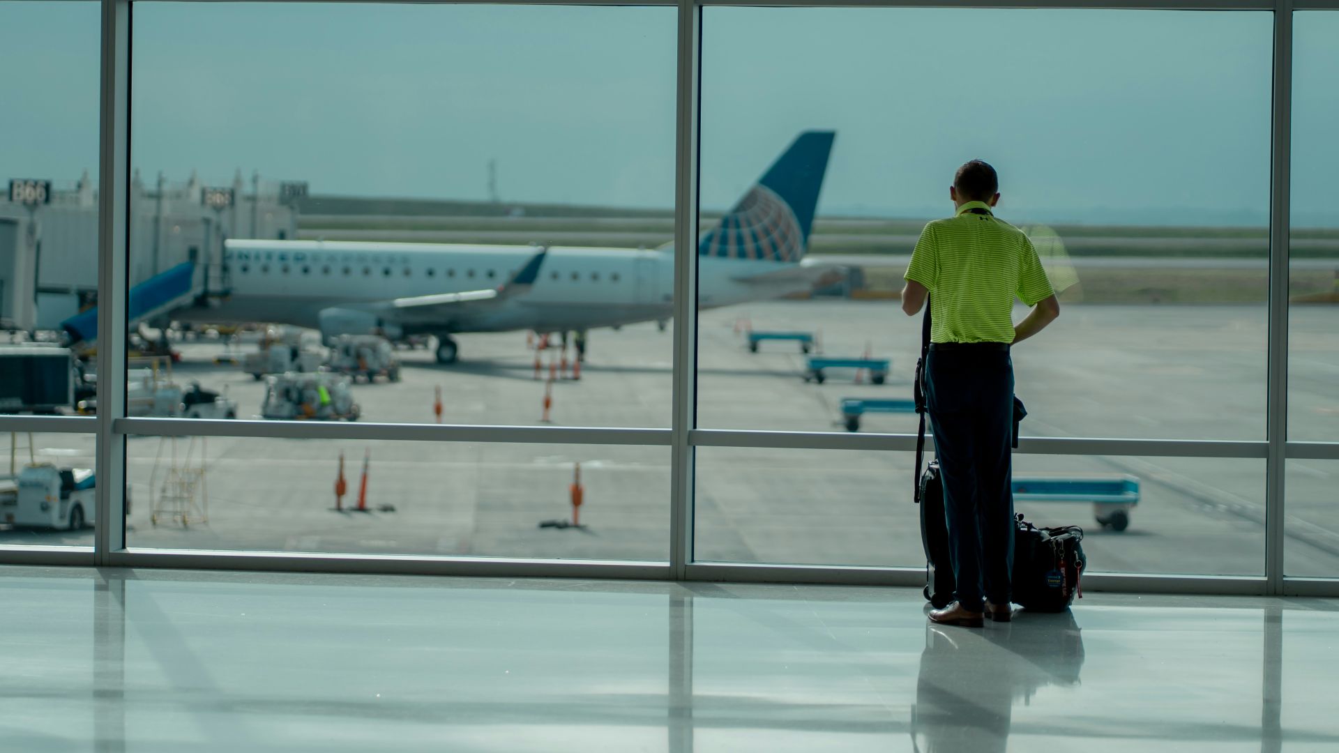a man standing in front of an airport window
