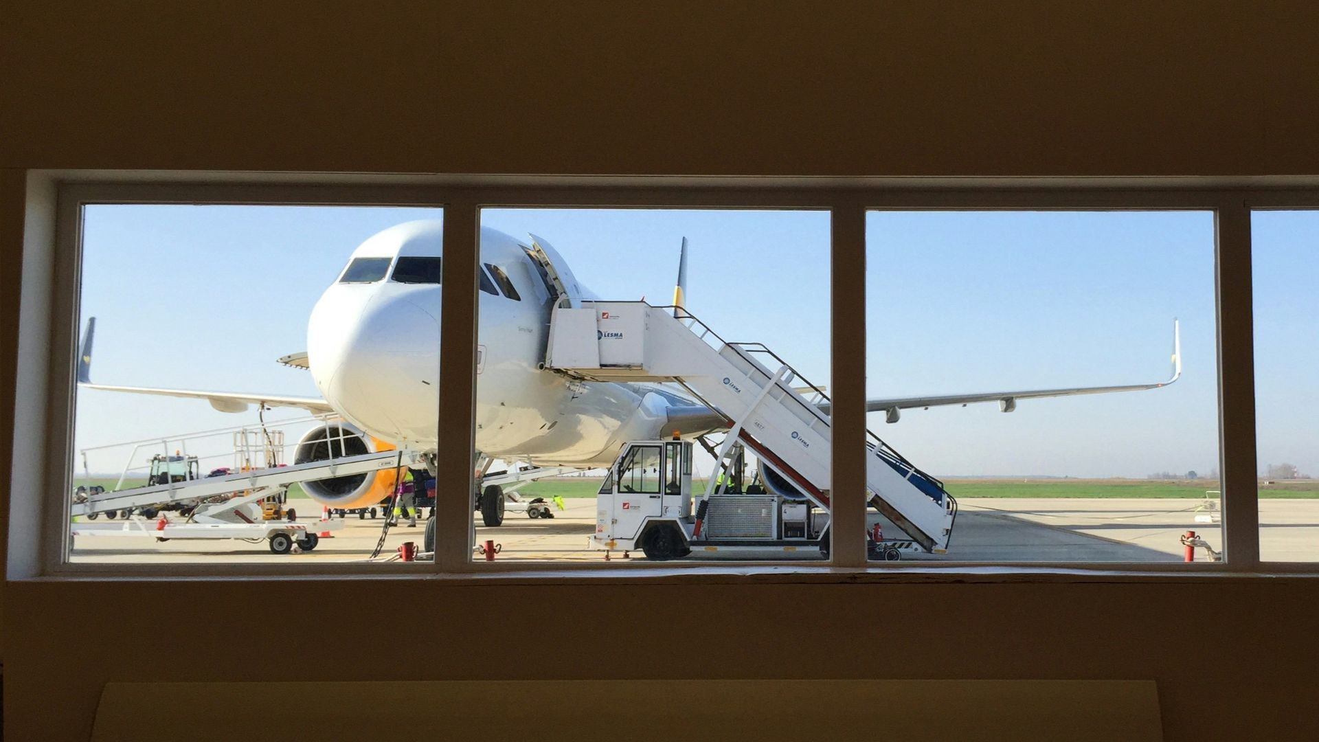 white truck beside white airplane