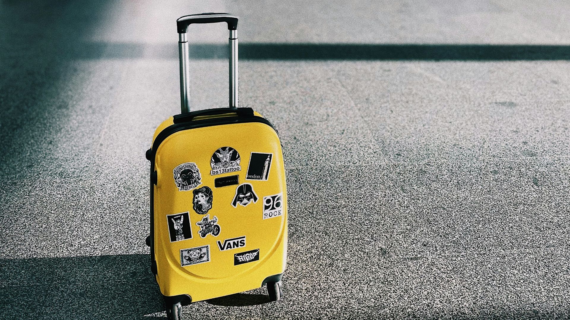 a yellow piece of luggage sitting on top of a floor