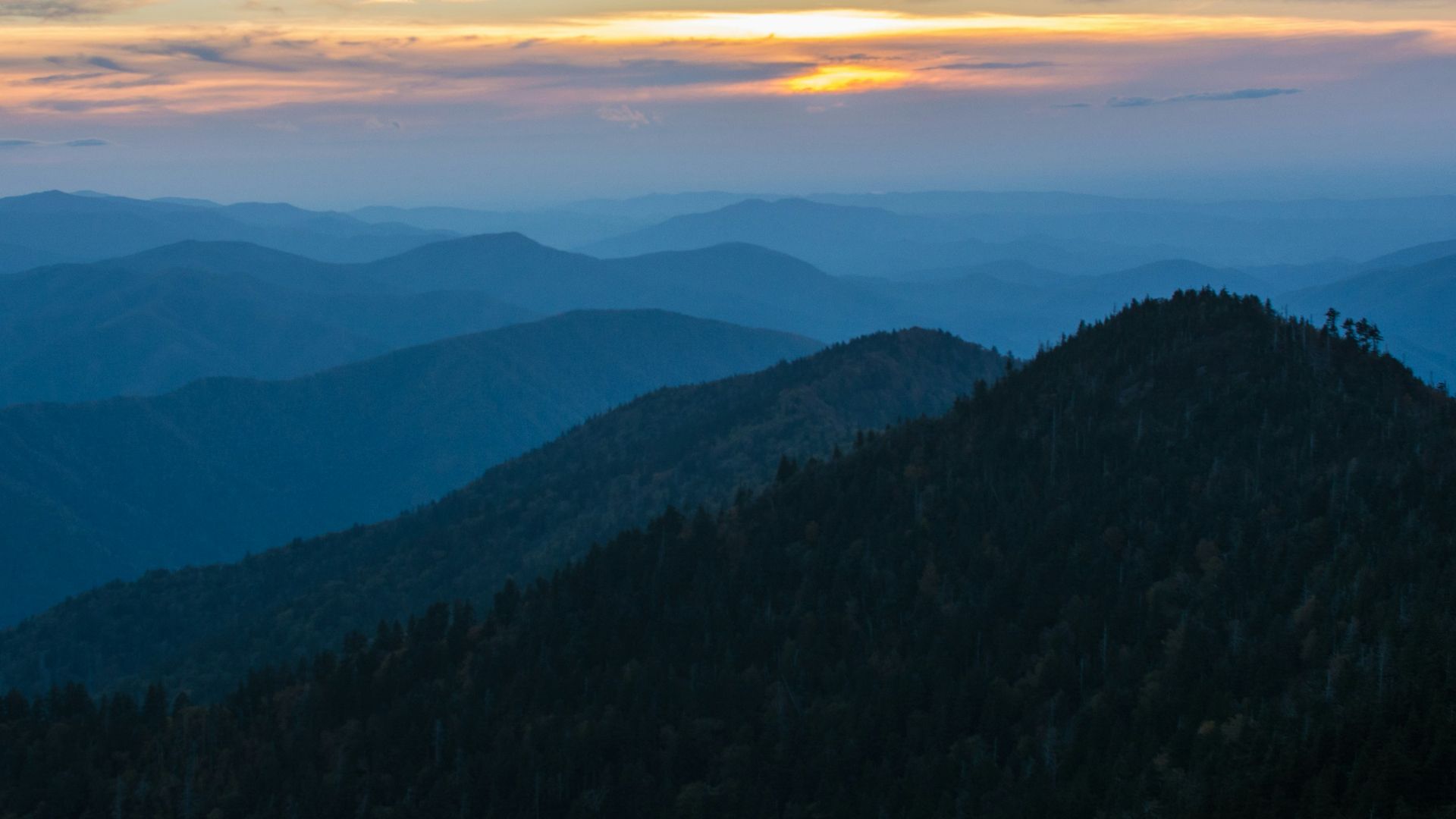 silhouette of mountain under white and yellow sky