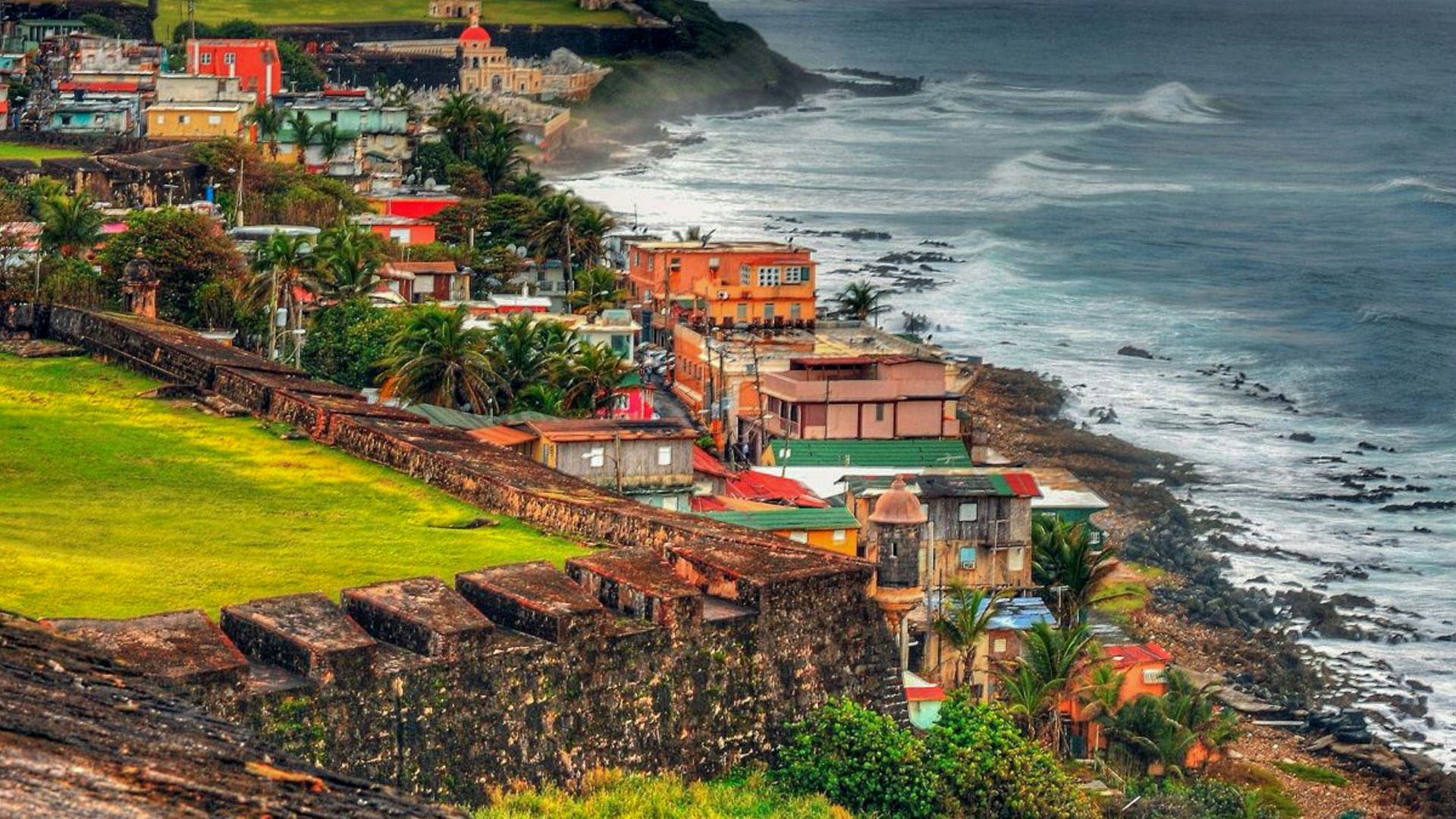 houses near sea under cloudy sky during daytime