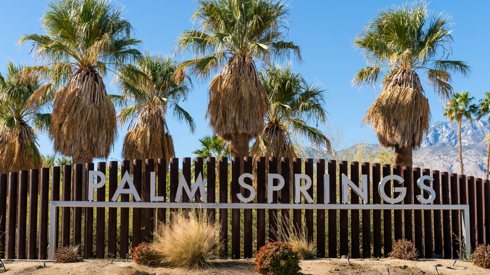 brown wooden fence with brown sand