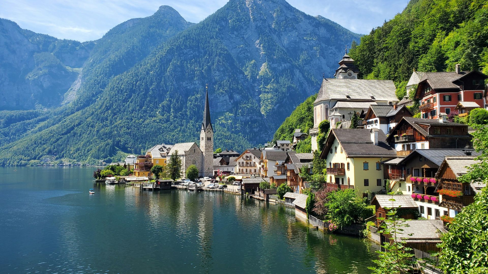 houses near body of water and mountain during daytime
