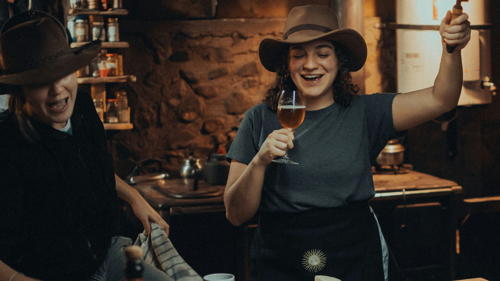 a couple of women standing next to each other in a kitchen