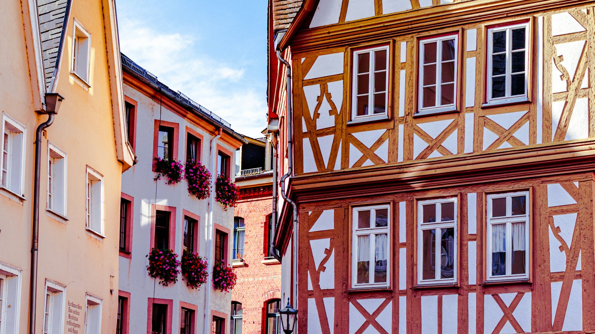 a cobblestone street lined with tall buildings