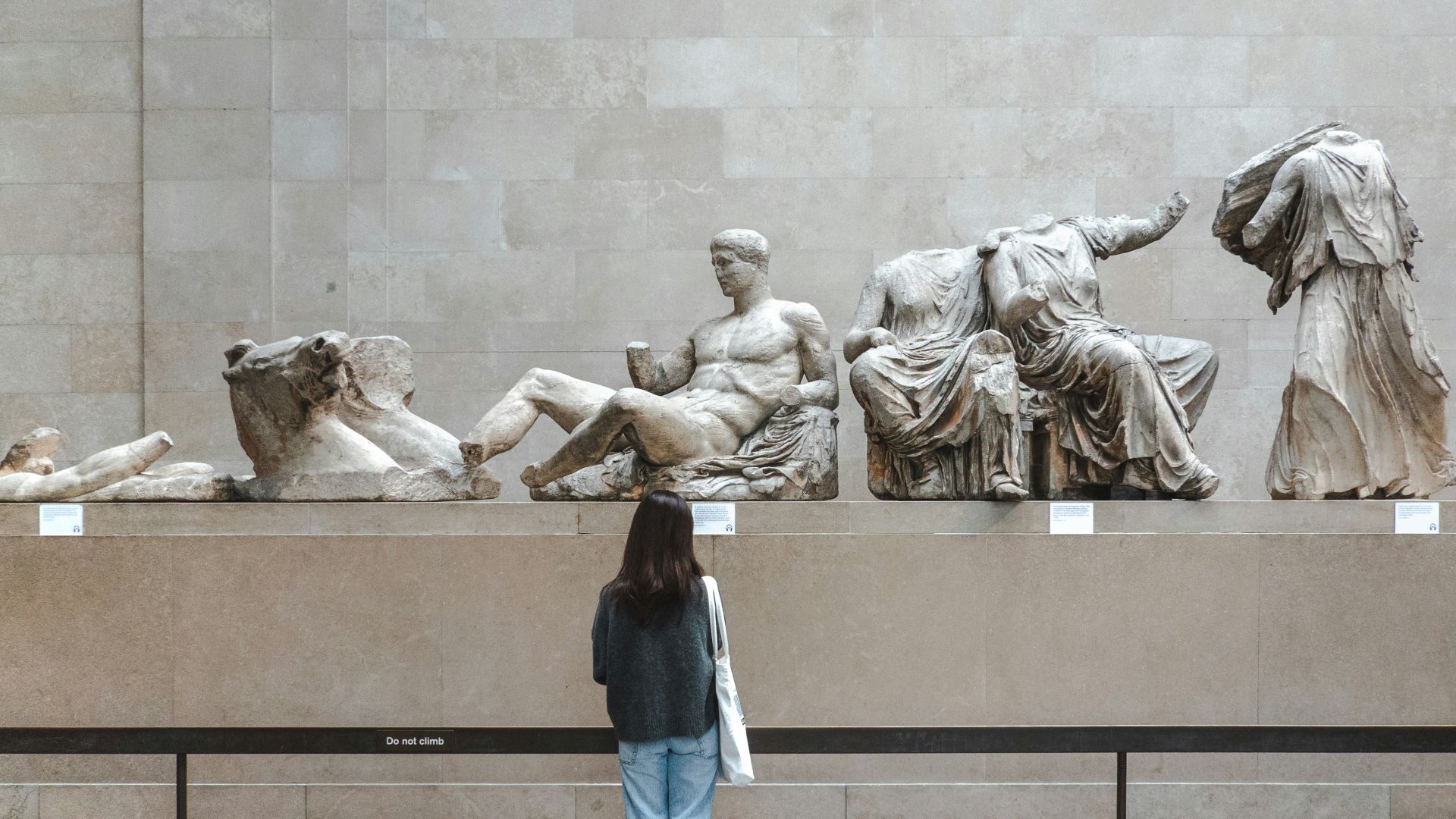 A woman standing in front of a statue