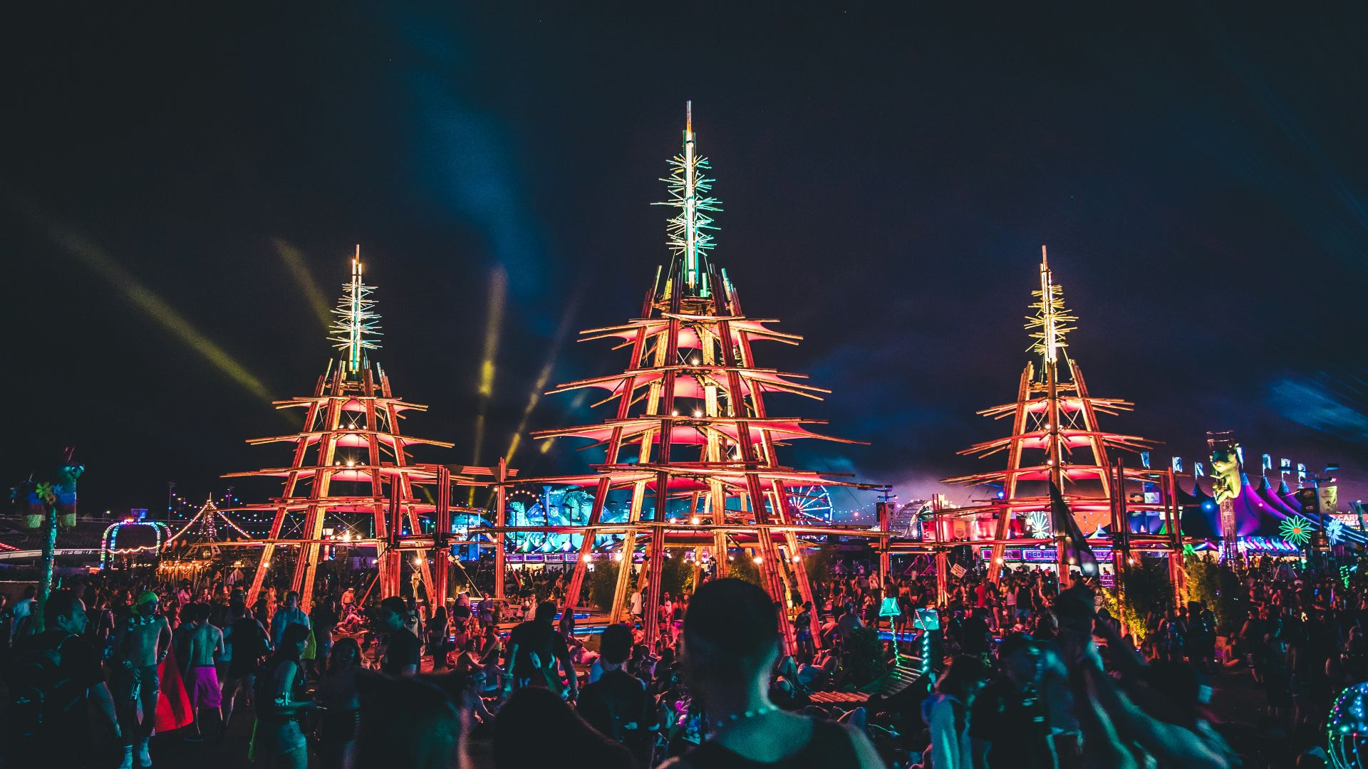 people gathering in front of brown tower during nighttime