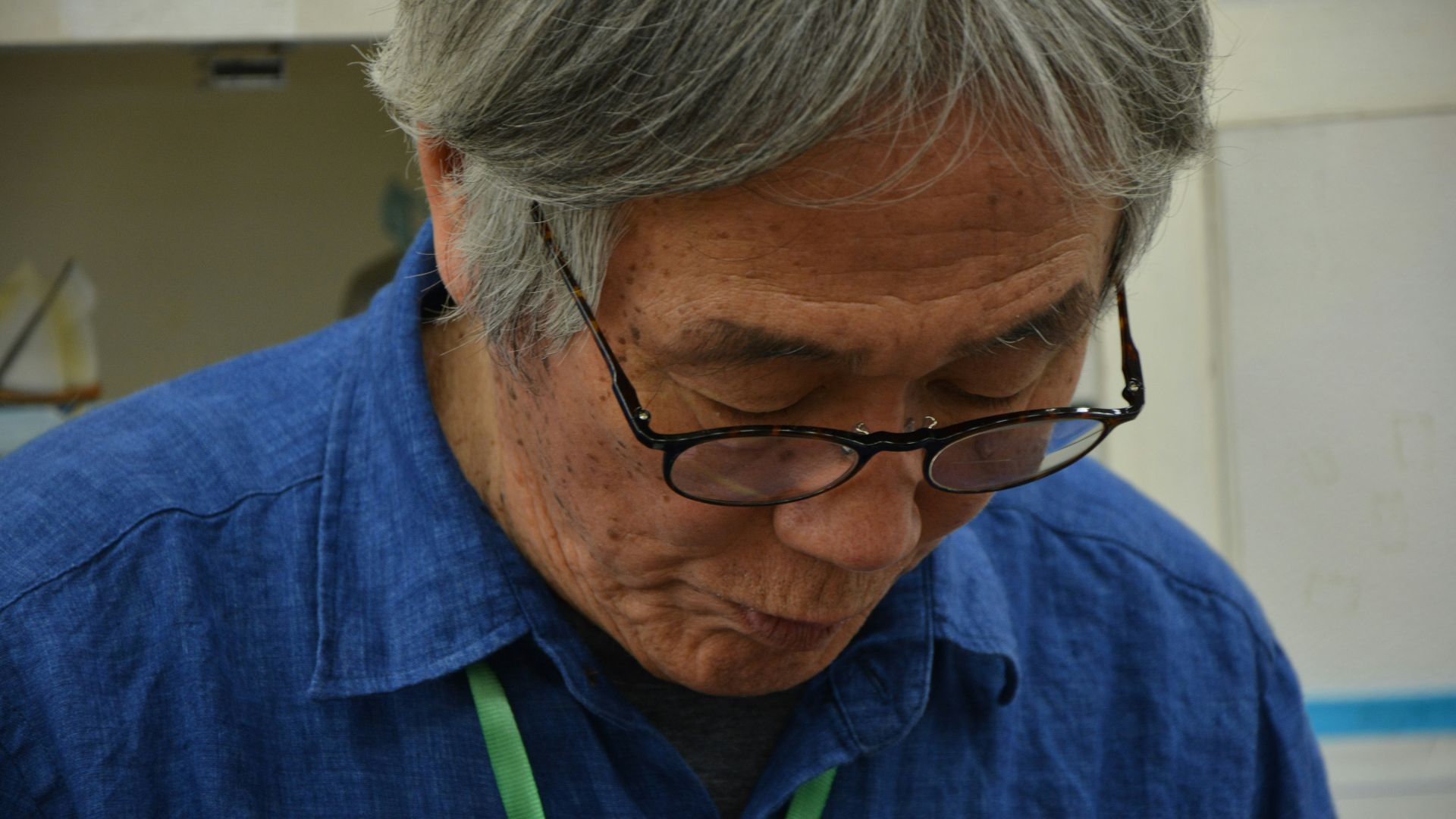 man in blue shirt wearing black framed eyeglasses
