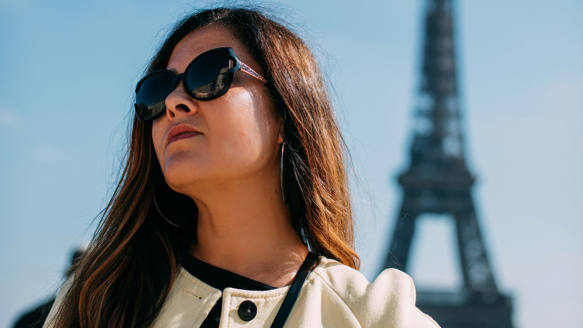 a woman standing in front of the eiffel tower