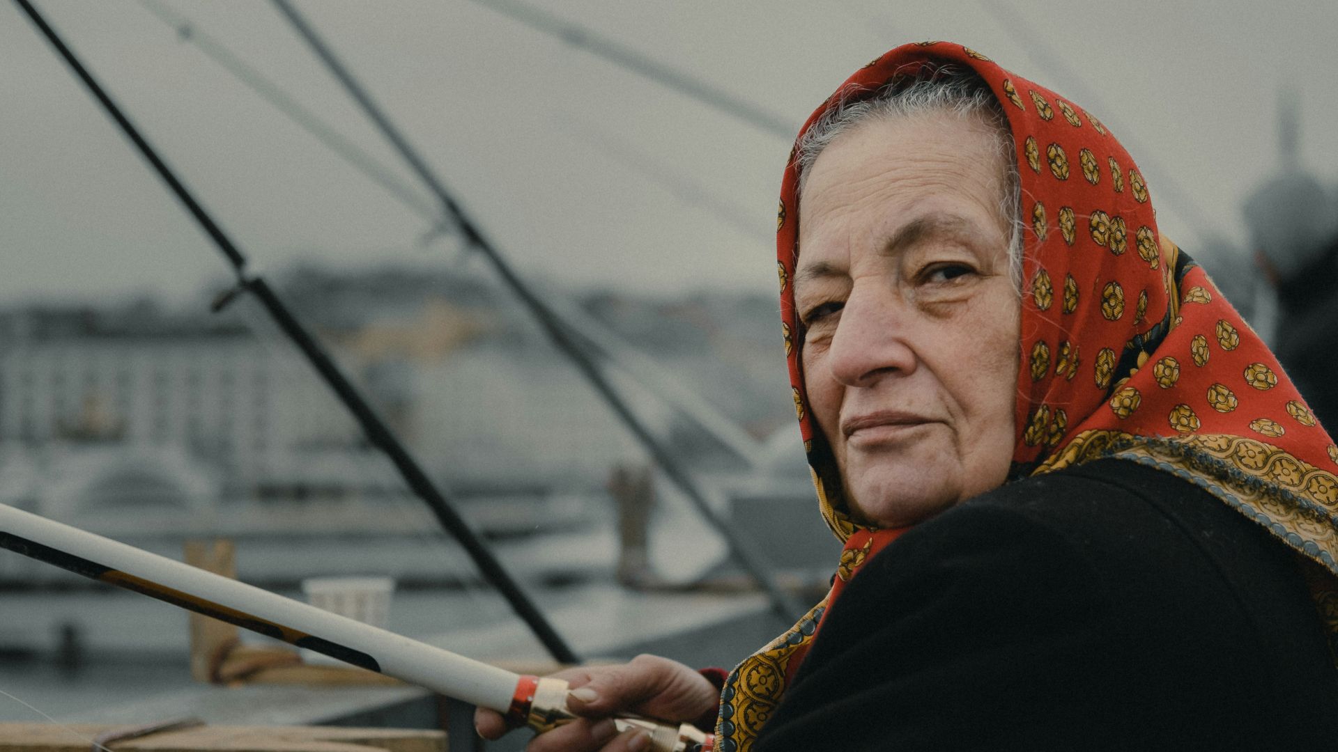 woman fishing on bridge during daytime