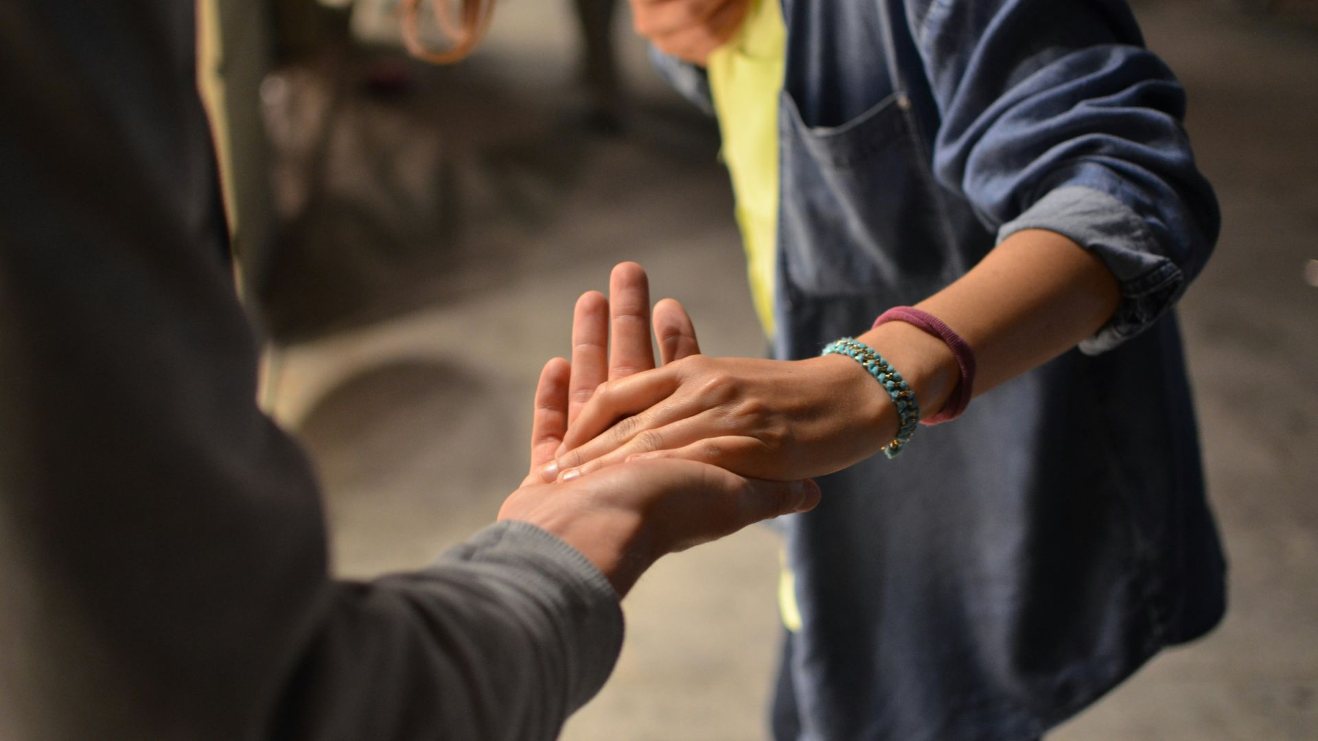 man and woman holding hands on street