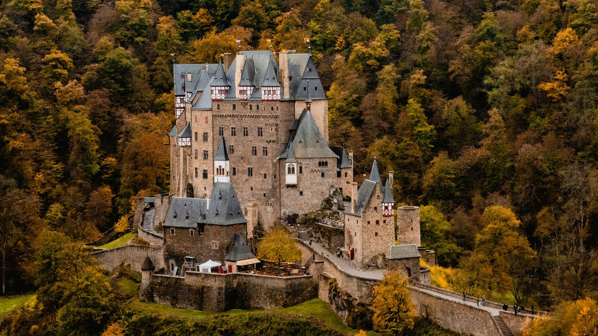 brown castle surrounded by trees under white sky