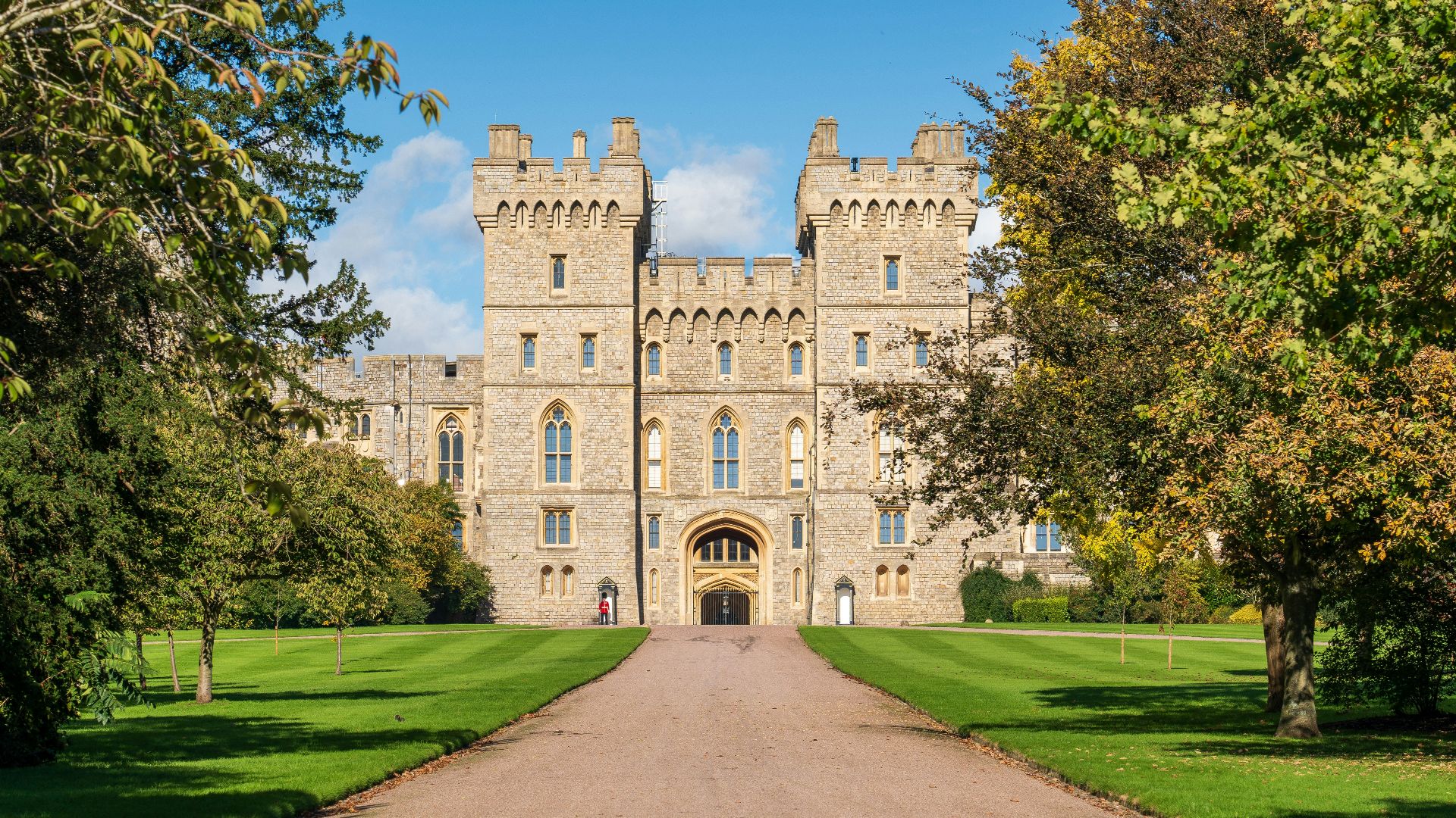 a large castle with a long driveway leading to it