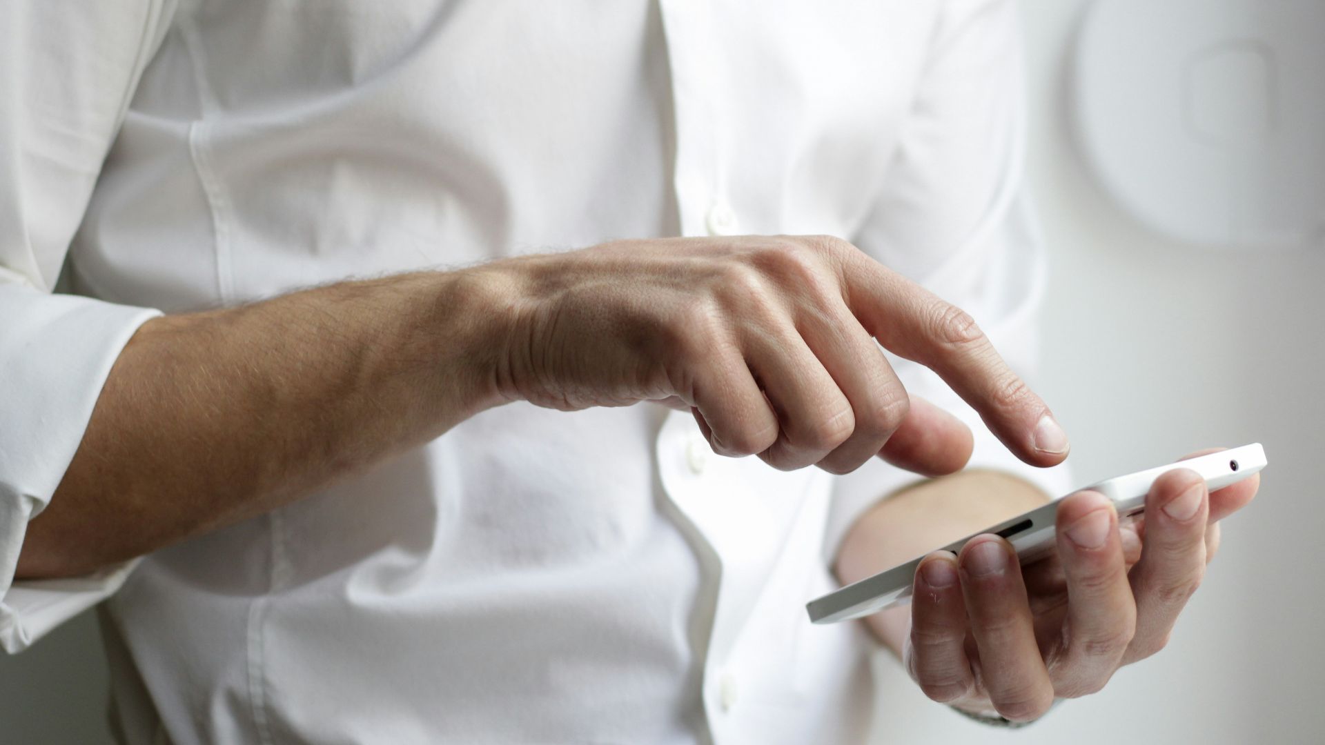 person holding white Android smartphone in white shirt