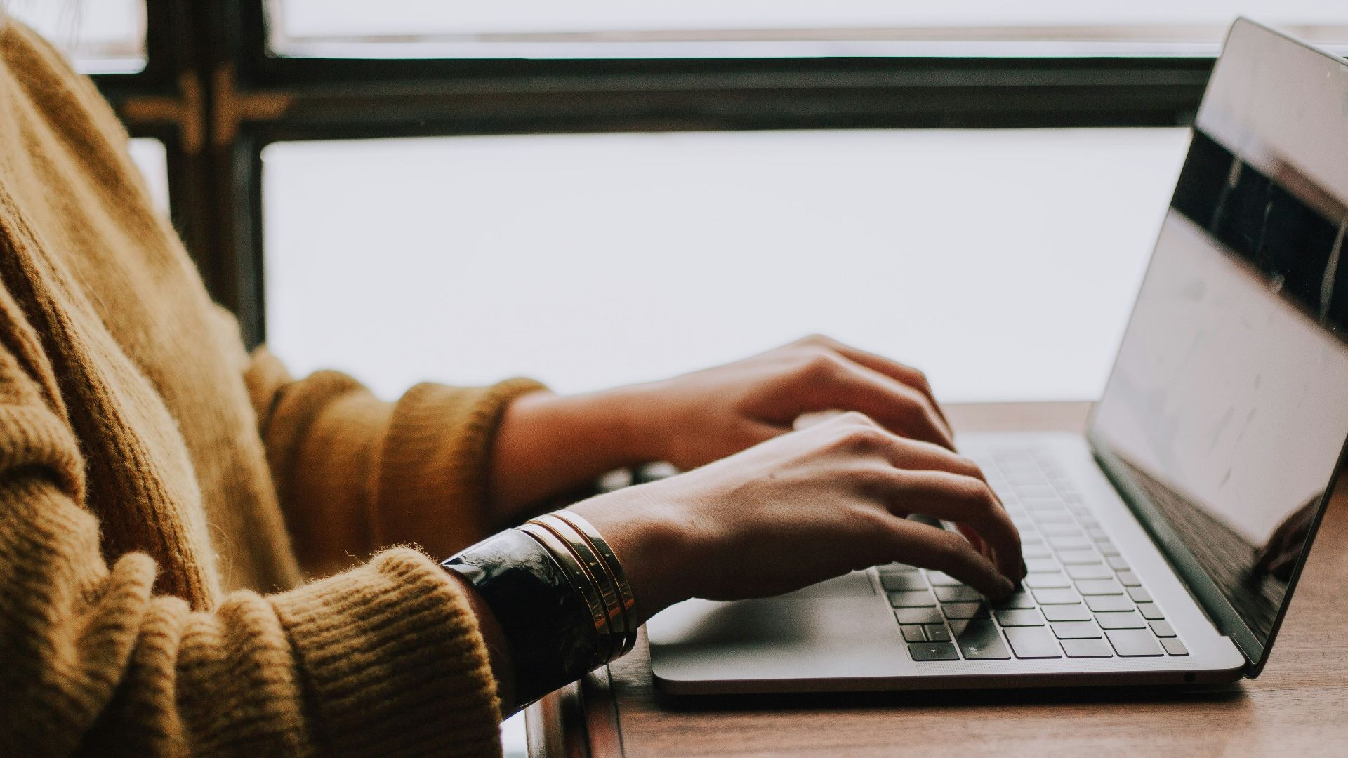 person sitting front of laptop
