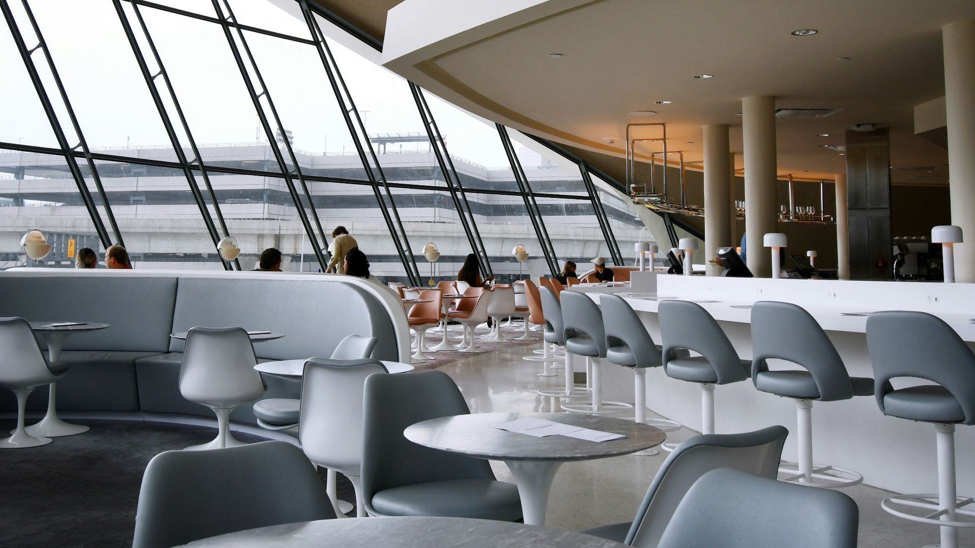 people sitting on white chairs inside building