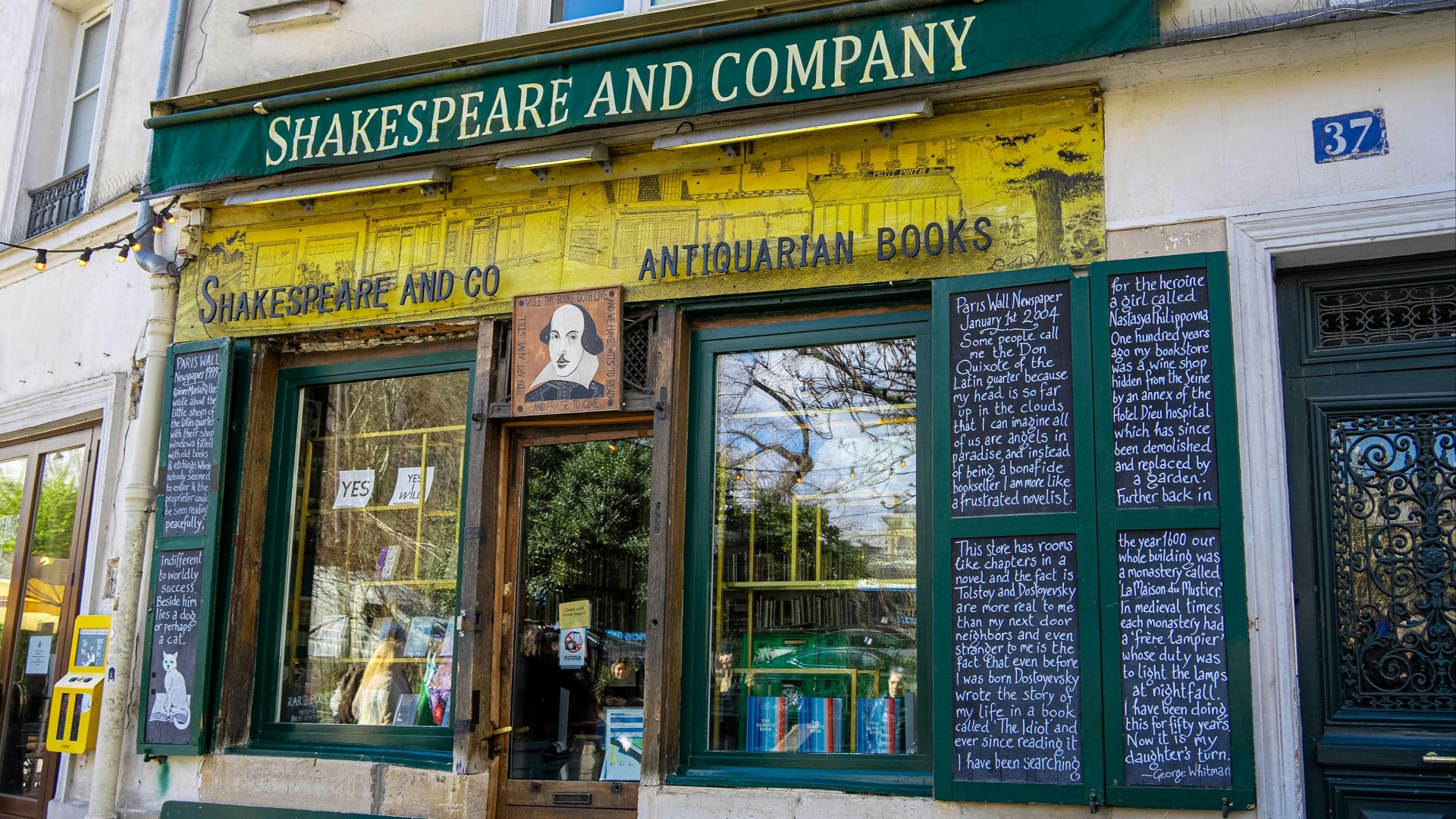 shakespeare and company store front with green and yellow awning