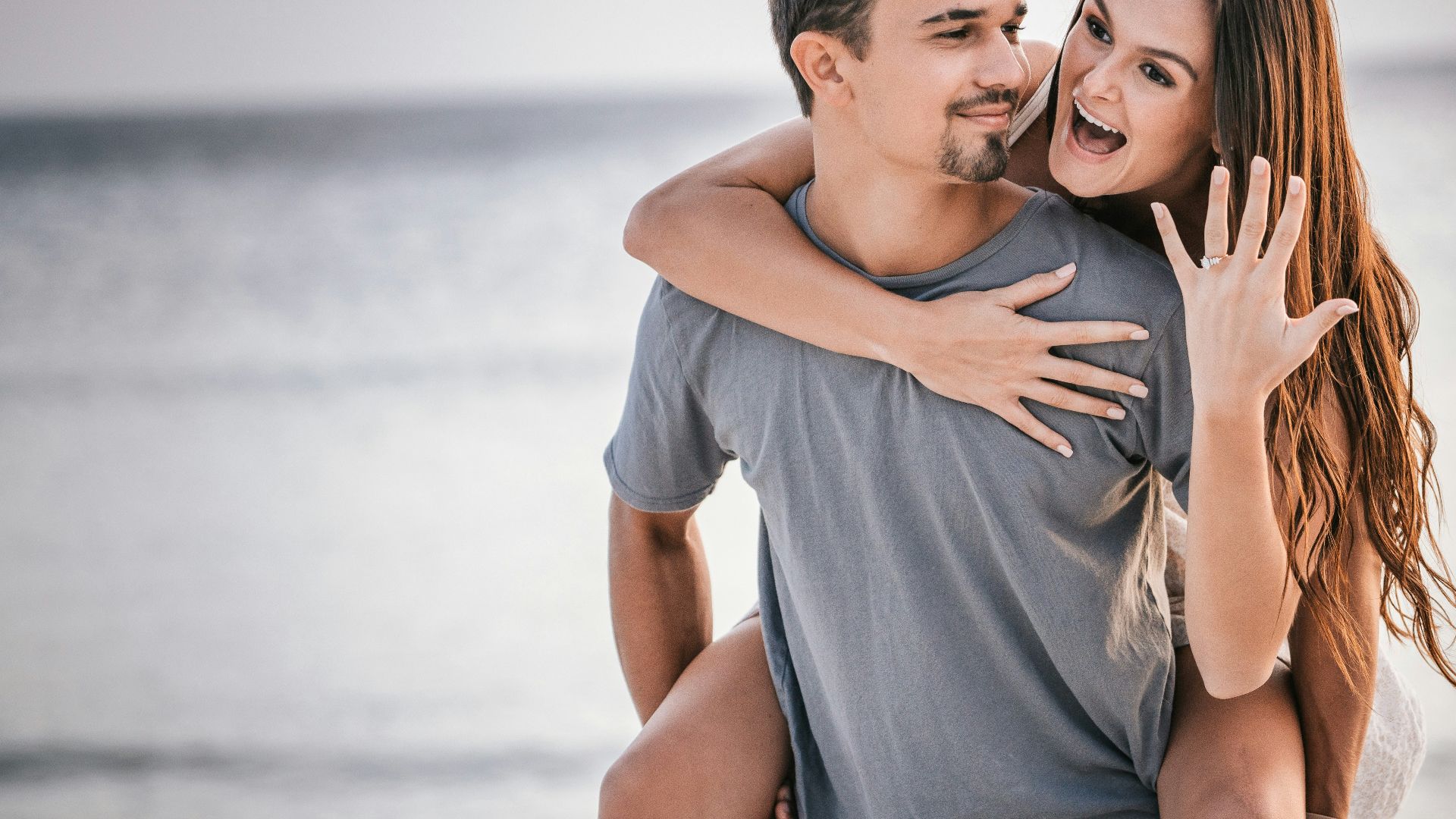 man in white crew neck t-shirt hugging woman in blue denim shorts
