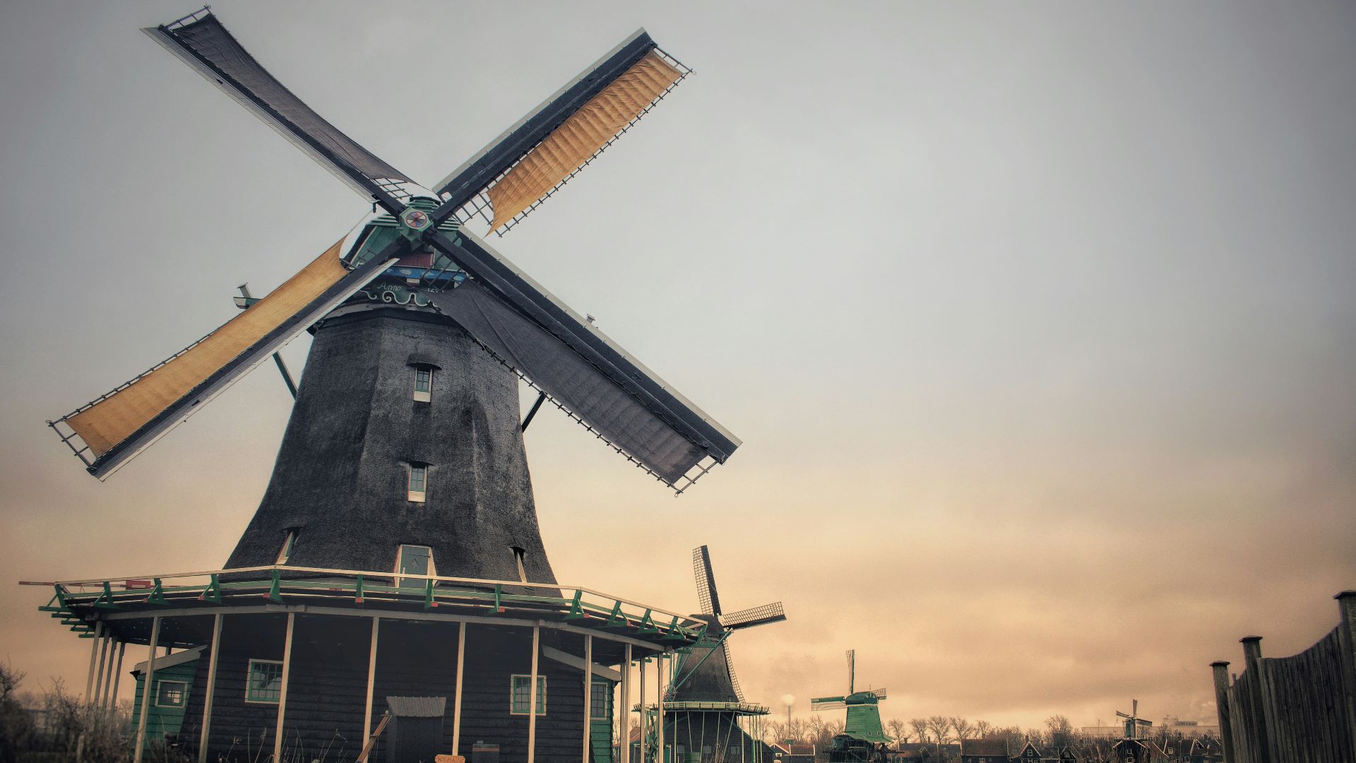 brown windmill under gray sky during daytime