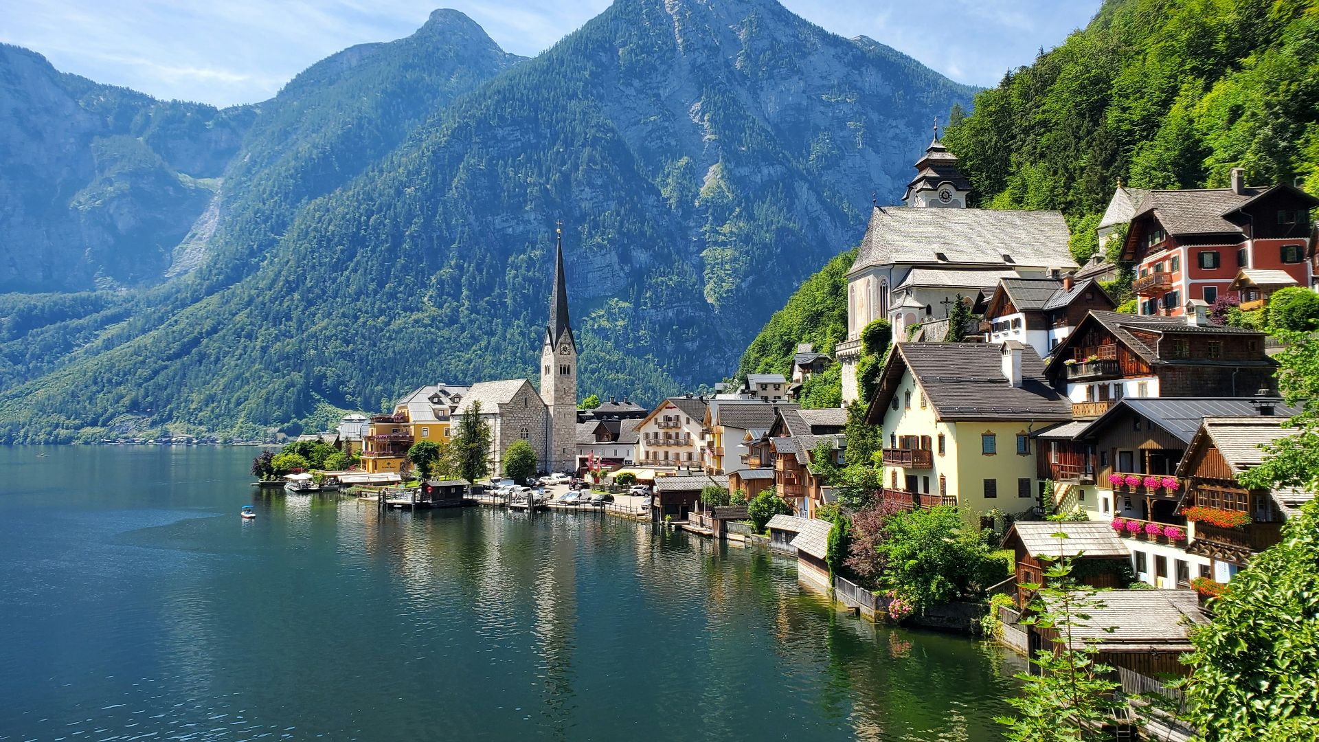 houses near body of water and mountain during daytime