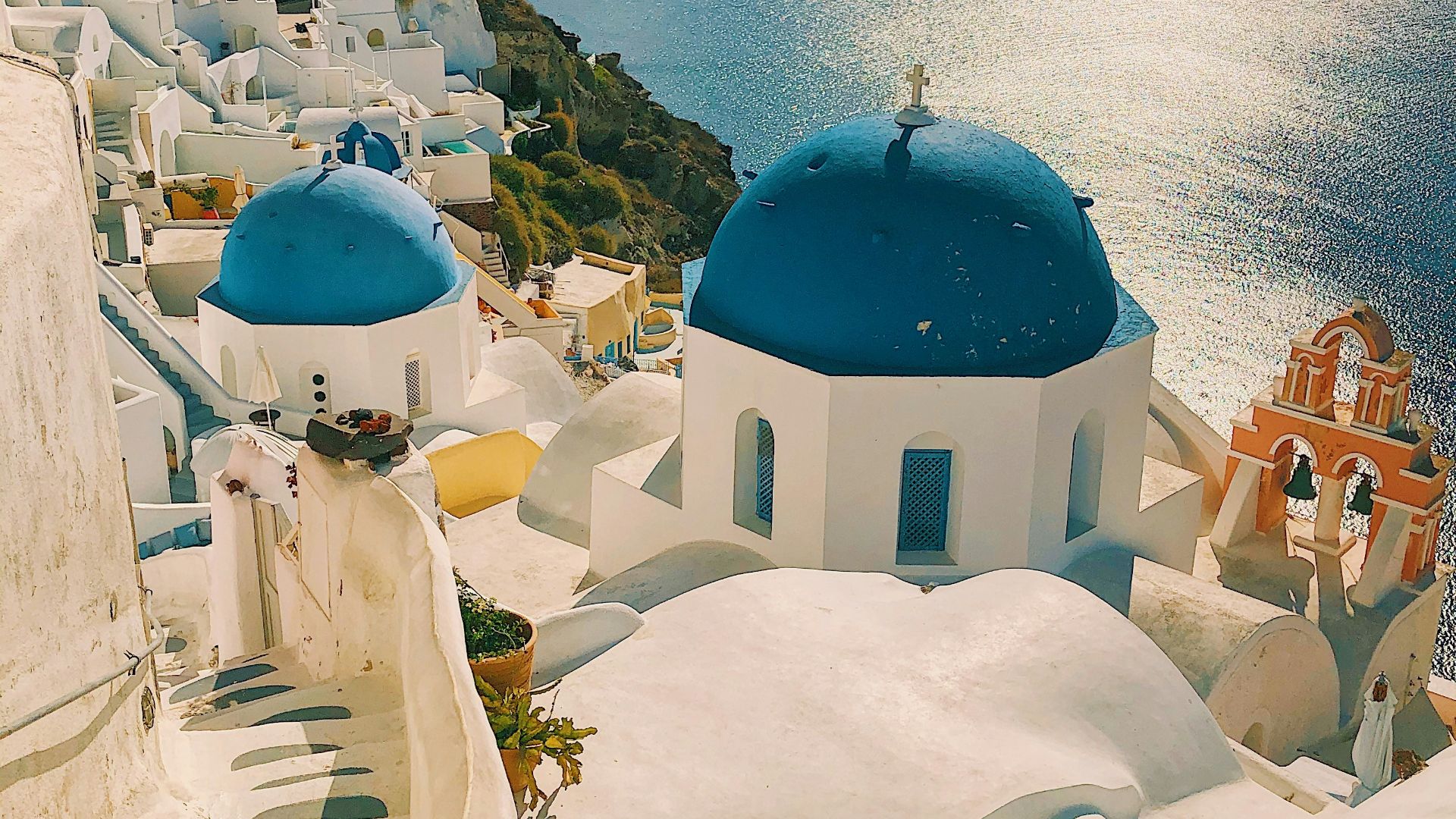 white and blue concrete building near body of water during daytime