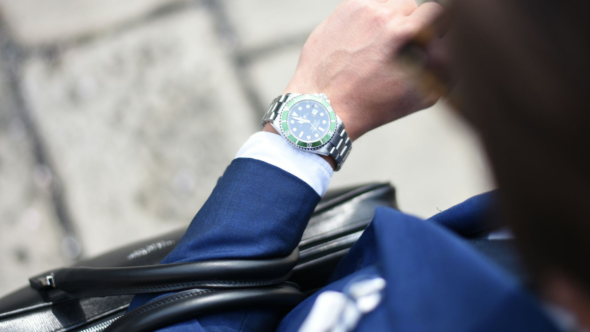 person looking at silver-colored analog watch