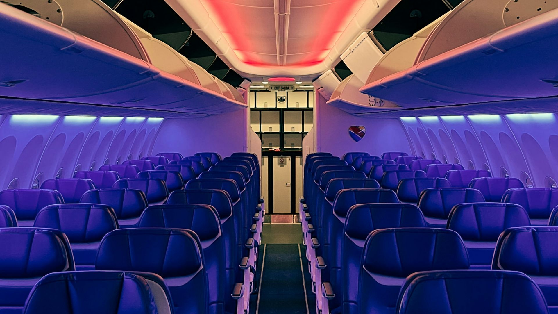 the inside of an airplane with blue seats