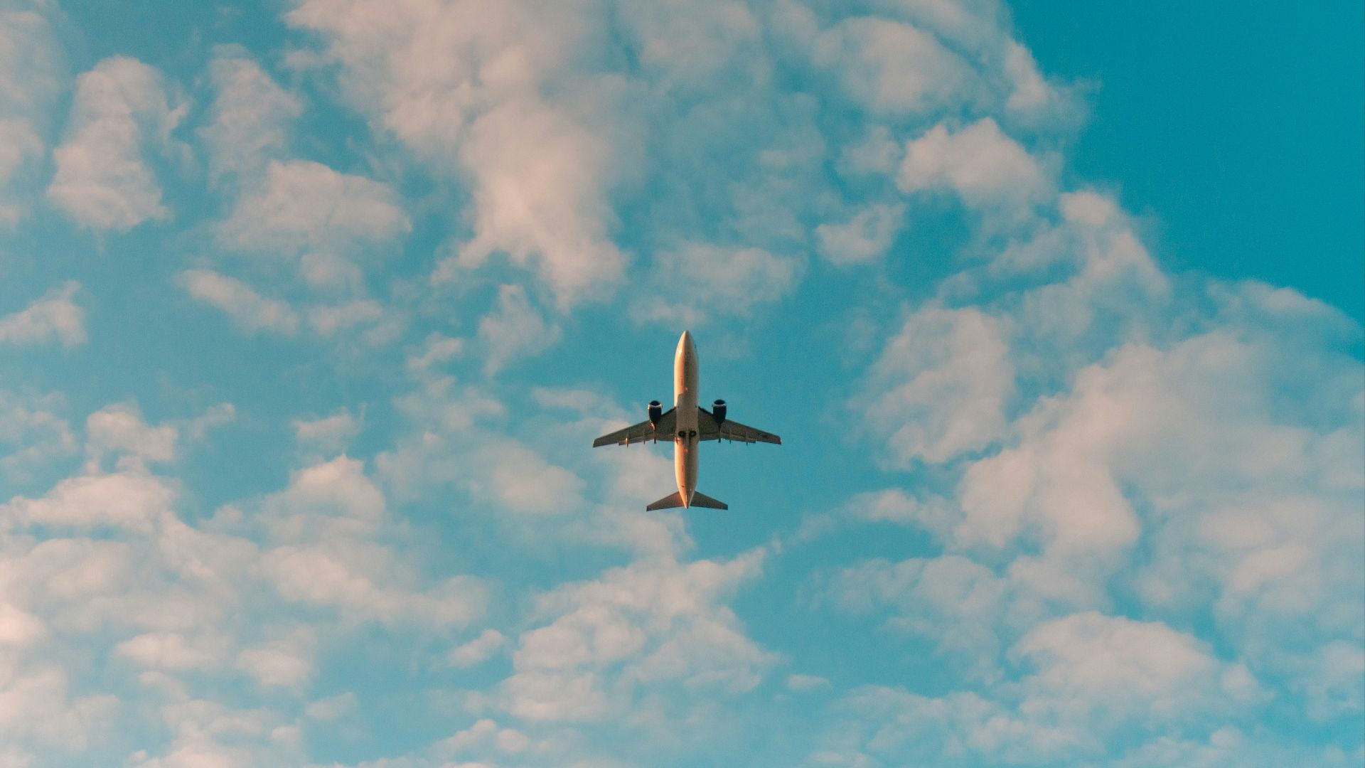 white airplane flying in the sky during daytime